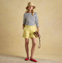 Joules HARBOUR Boat Neck 100% Cotton Breton Top Cream/Navy Stripe front view worn with yellow shorts and a sun hat.