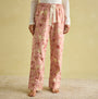 Joules STELLA Womens Pyjama Bottoms Pink Dogs front view showcasing the elasticated waist and slanted side pockets.