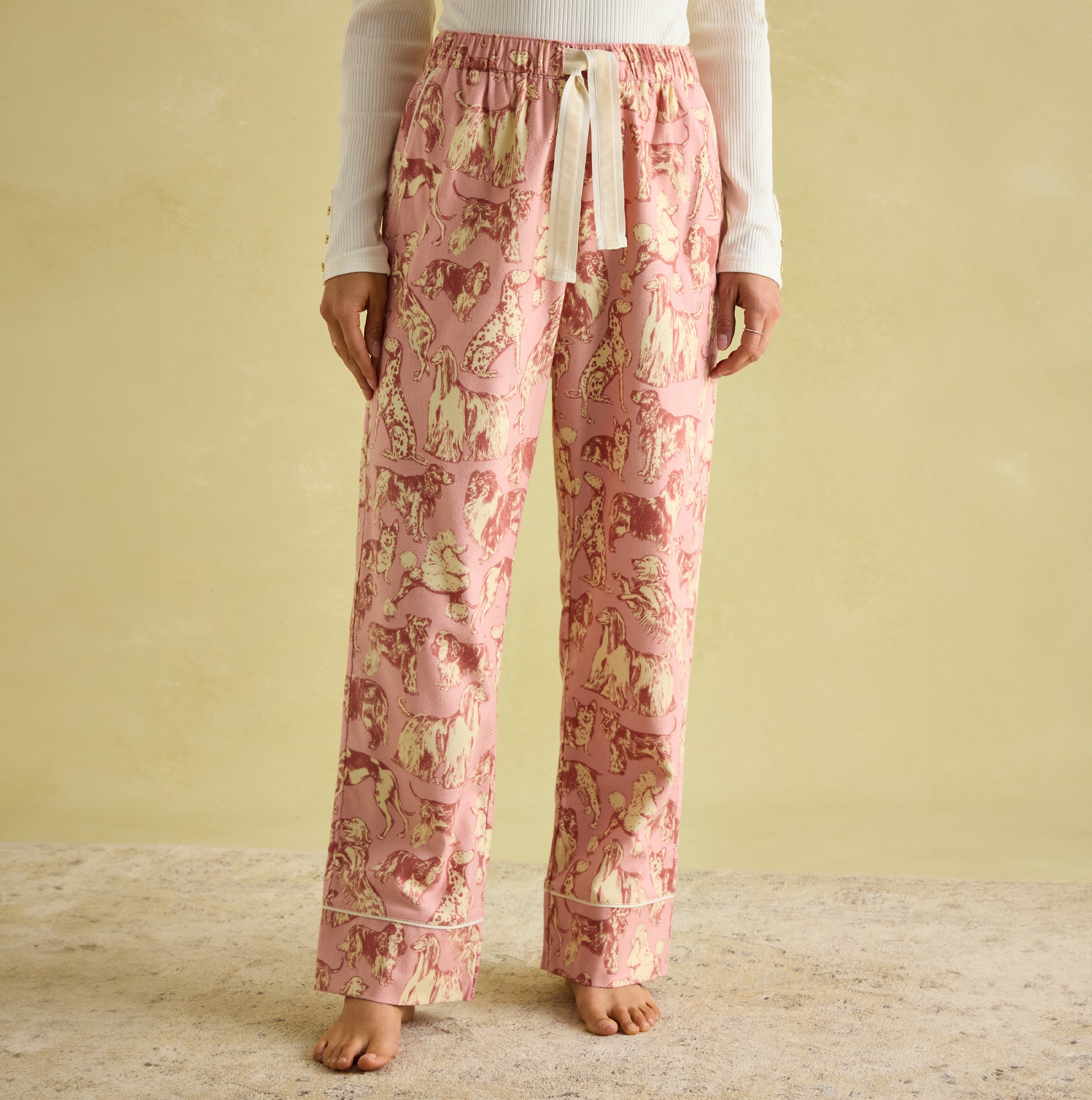 Joules STELLA Womens Pyjama Bottoms Pink Dogs front view showcasing the elasticated waist and slanted side pockets.