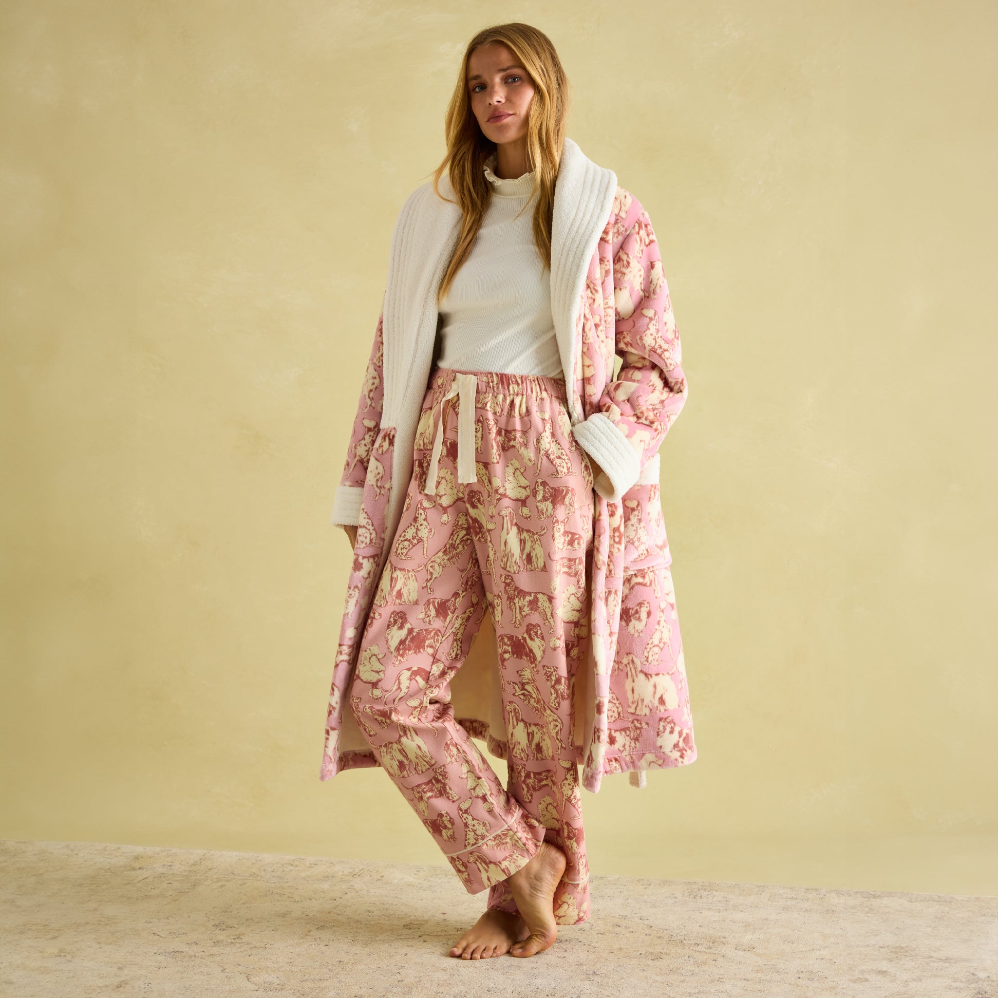 Joules STELLA Womens Pyjama Bottoms Pink Dogs front view, featuring a relaxed fit with hand-drawn dog print and elasticated waist.