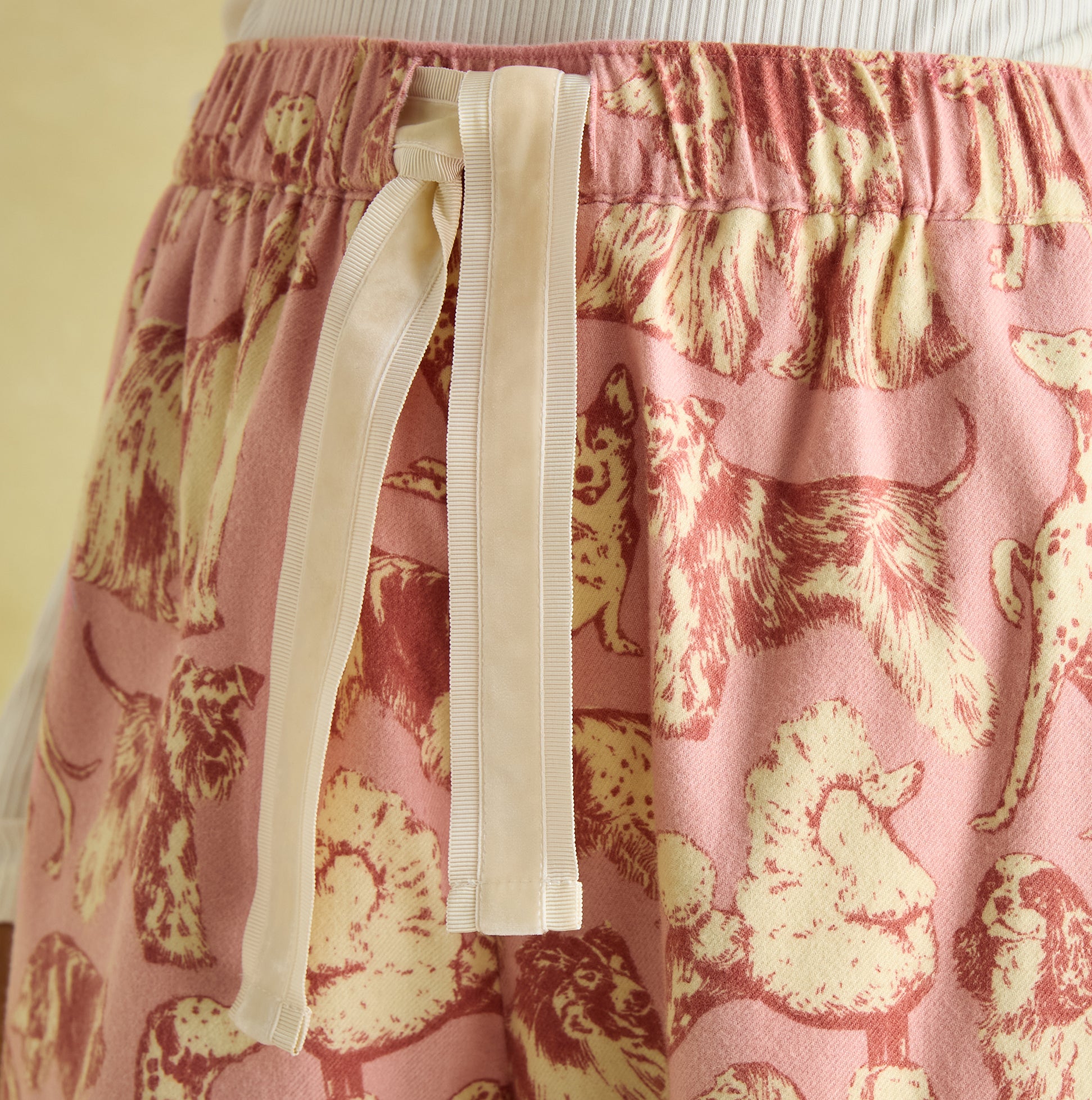 Joules STELLA Womens Pyjama Bottoms Pink Dogs detail view of elasticated waistband and hand-drawn dog print.