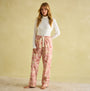 Joules STELLA Womens Pyjama Bottoms Pink Dogs front view on model, featuring a hand-drawn print and elasticated waist.