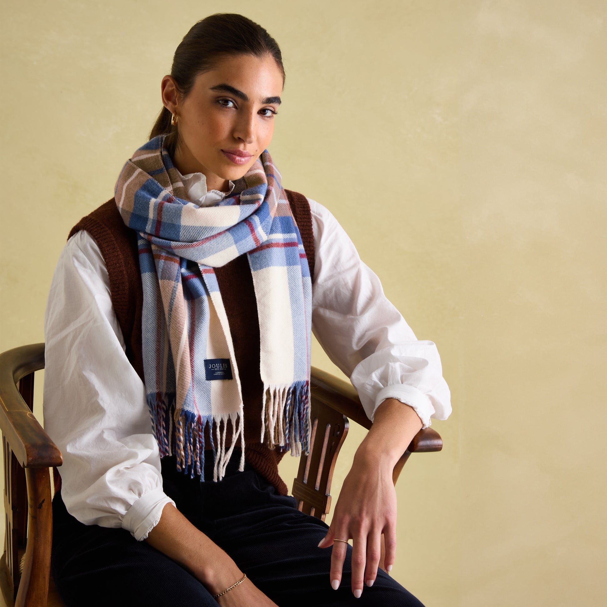 Joules LANGTREE Womens Scarf Cream Check worn by model, showcasing checked pattern and tasselled ends.