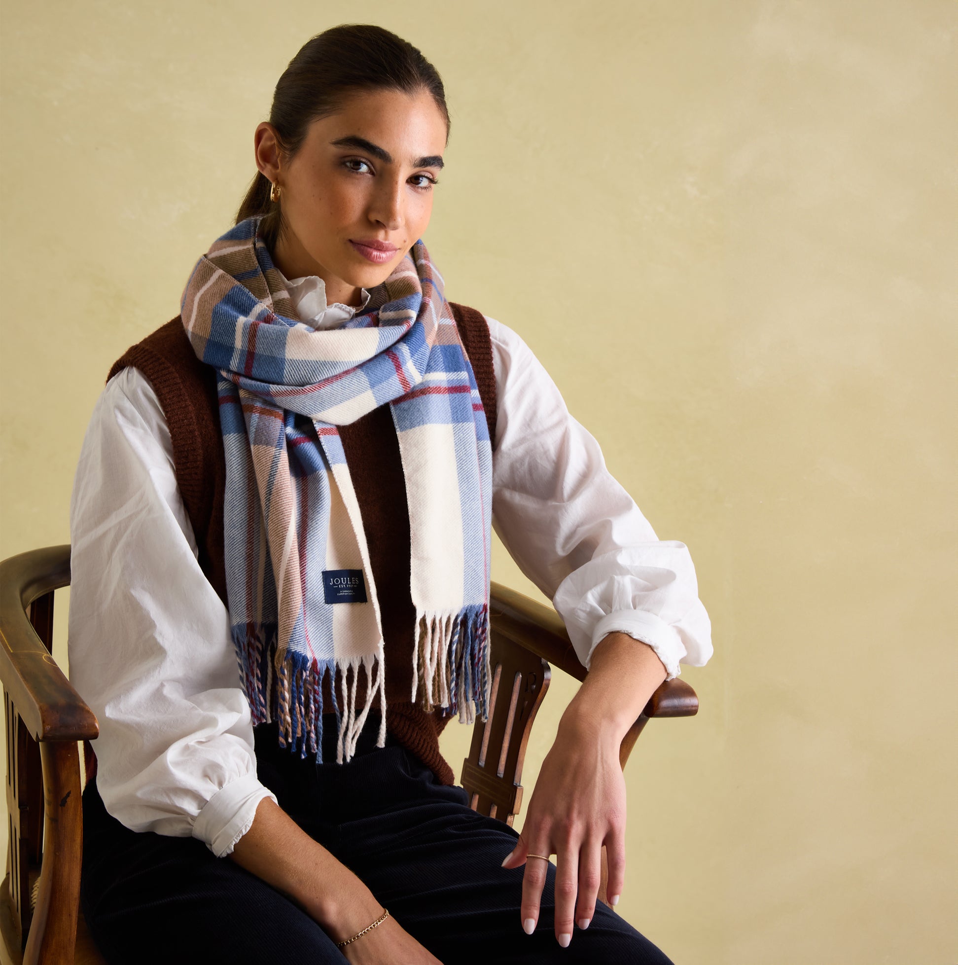 Joules LANGTREE Womens Scarf Cream Check worn by model, showcasing checked pattern and tasselled ends.