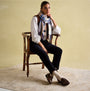 Joules LANGTREE Womens Scarf Cream Check, front view on model seated, showcasing checked pattern and tasselled ends.