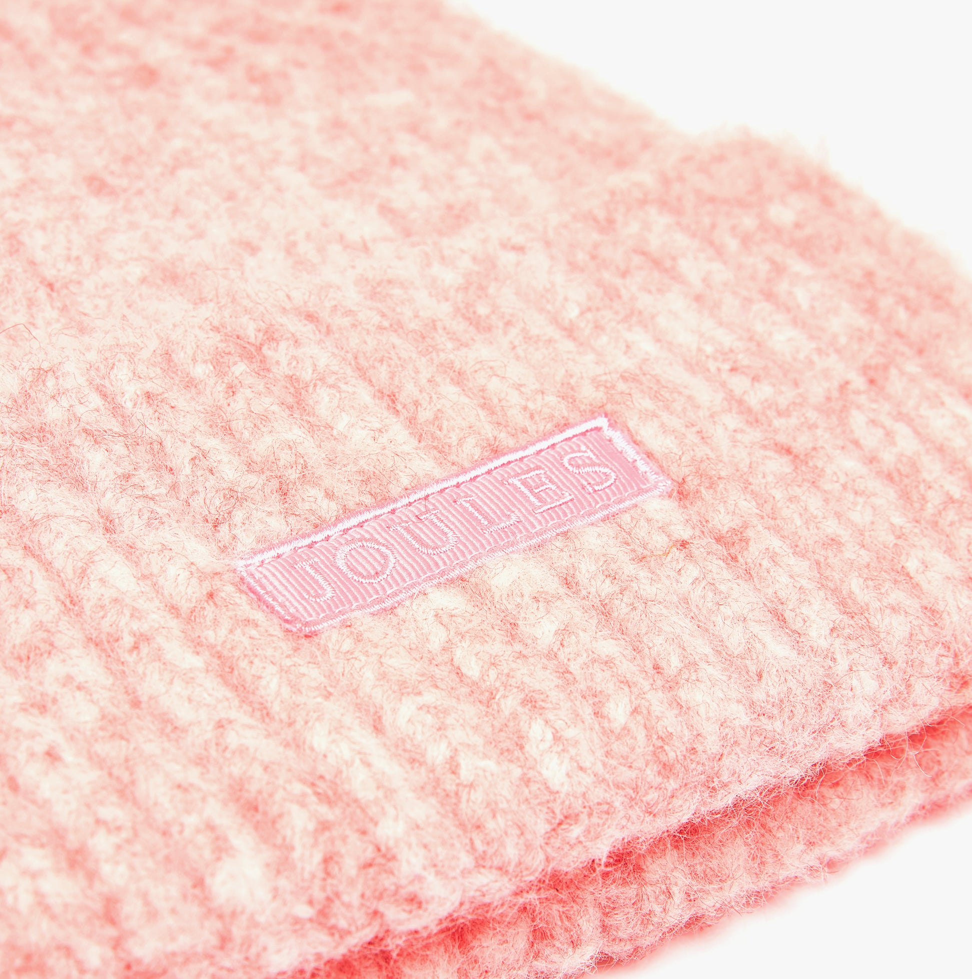 Joules CAVERSHAM Womens Beanie Pink detail view showing the fabric texture and logo tag.