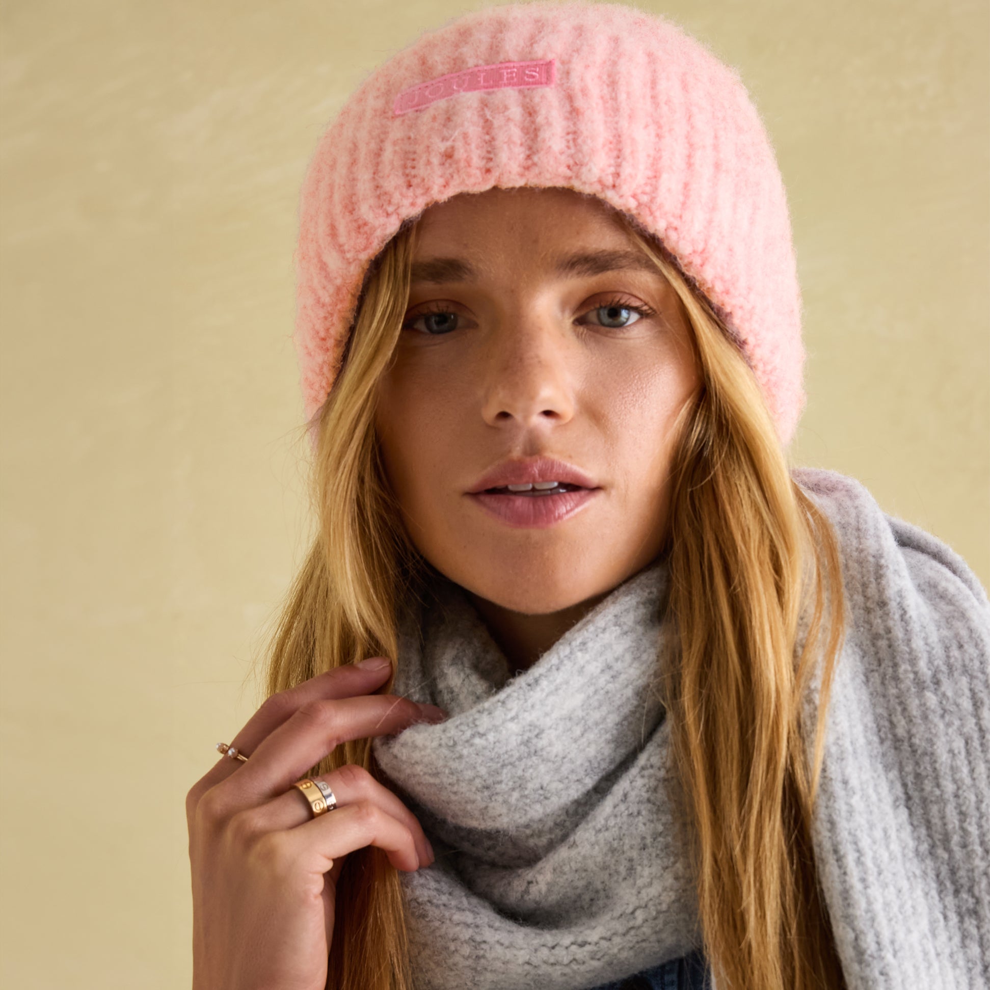 Joules CAVERSHAM Womens Beanie Pink front view worn by model with gray scarf.