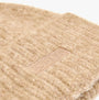 Joules CAVERSHAM Womens Beanie Oat detail view showcasing soft texture and logo patch.