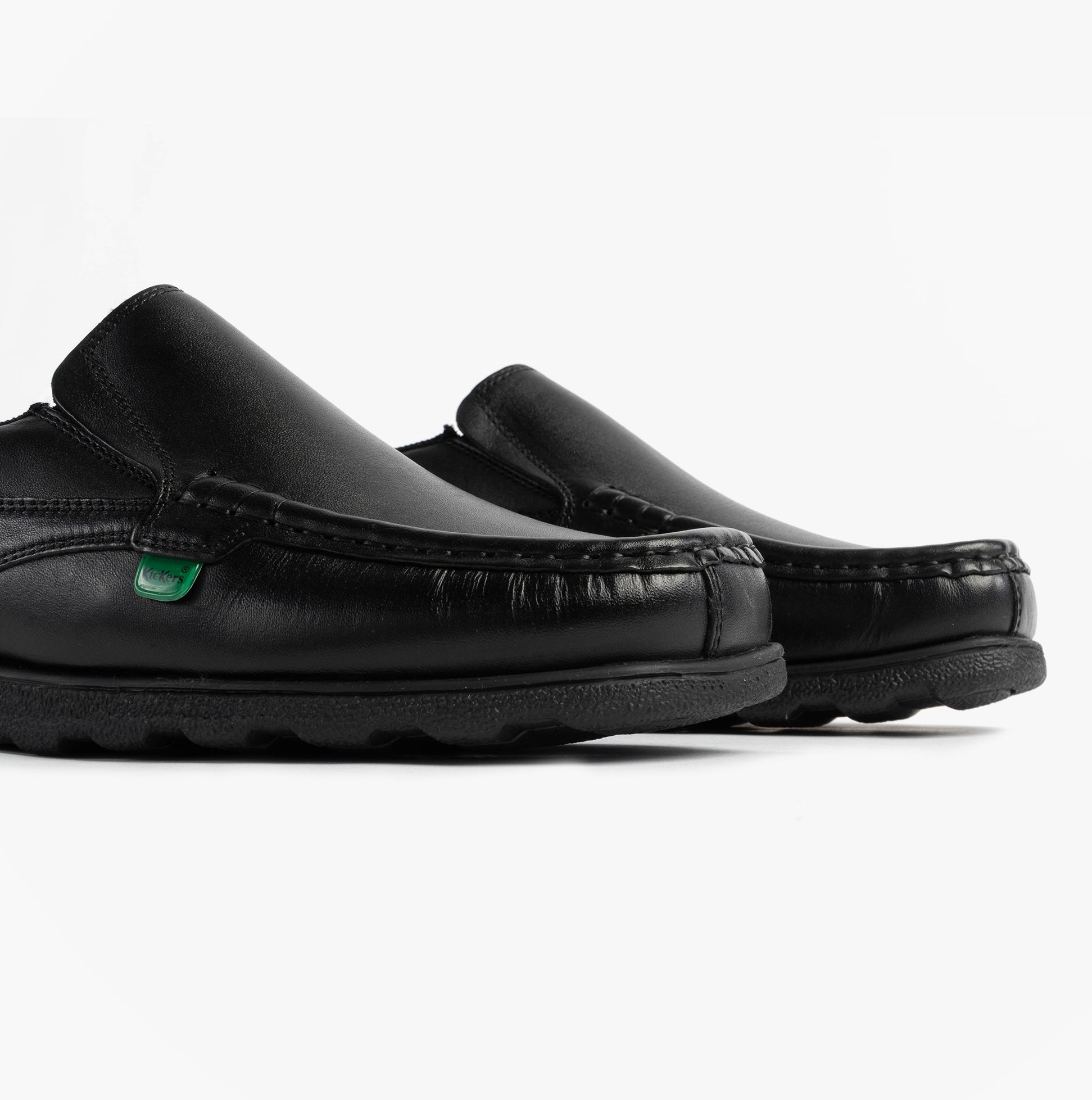 Kickers 114245 FRAGMA SLIP Boys School Shoes Black side view showing leather upper and rubber sole.