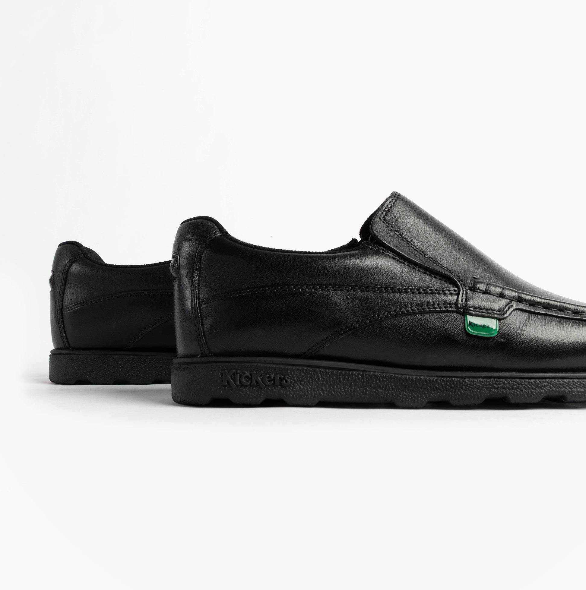Kickers 114245 FRAGMA SLIP Boys School Shoes Black side view showcasing leather upper and rubber sole.