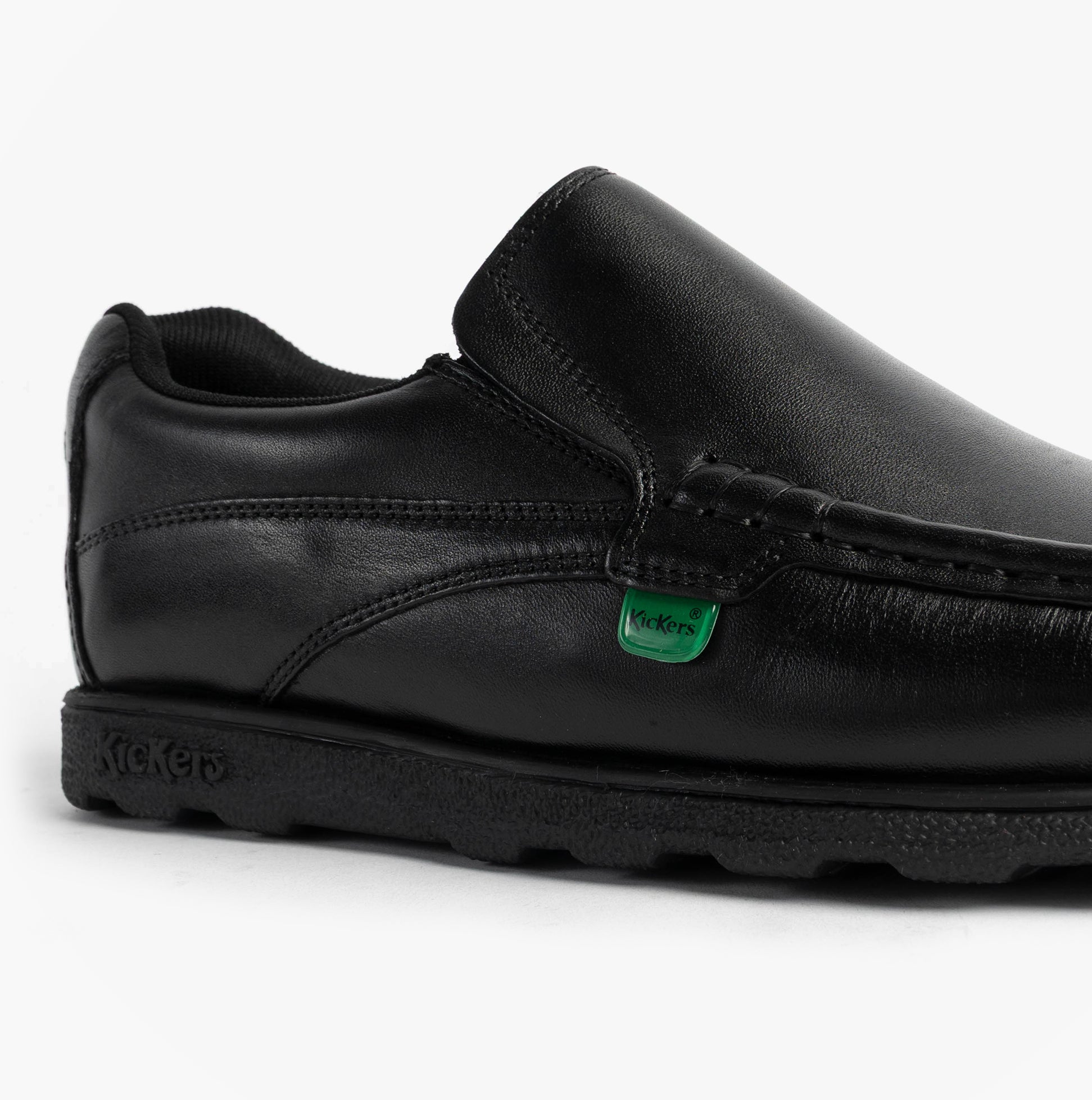 Kickers 114245 FRAGMA SLIP Boys School Shoes Black side view showcasing leather upper and rubber sole.
