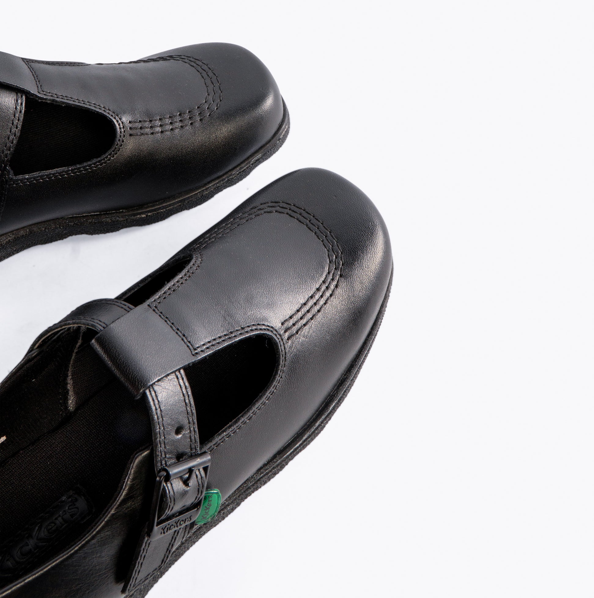 Kickers 115711 FRAGMA T-BUCKLE Girls School Shoes Black top view showcasing the buckle and leather upper.