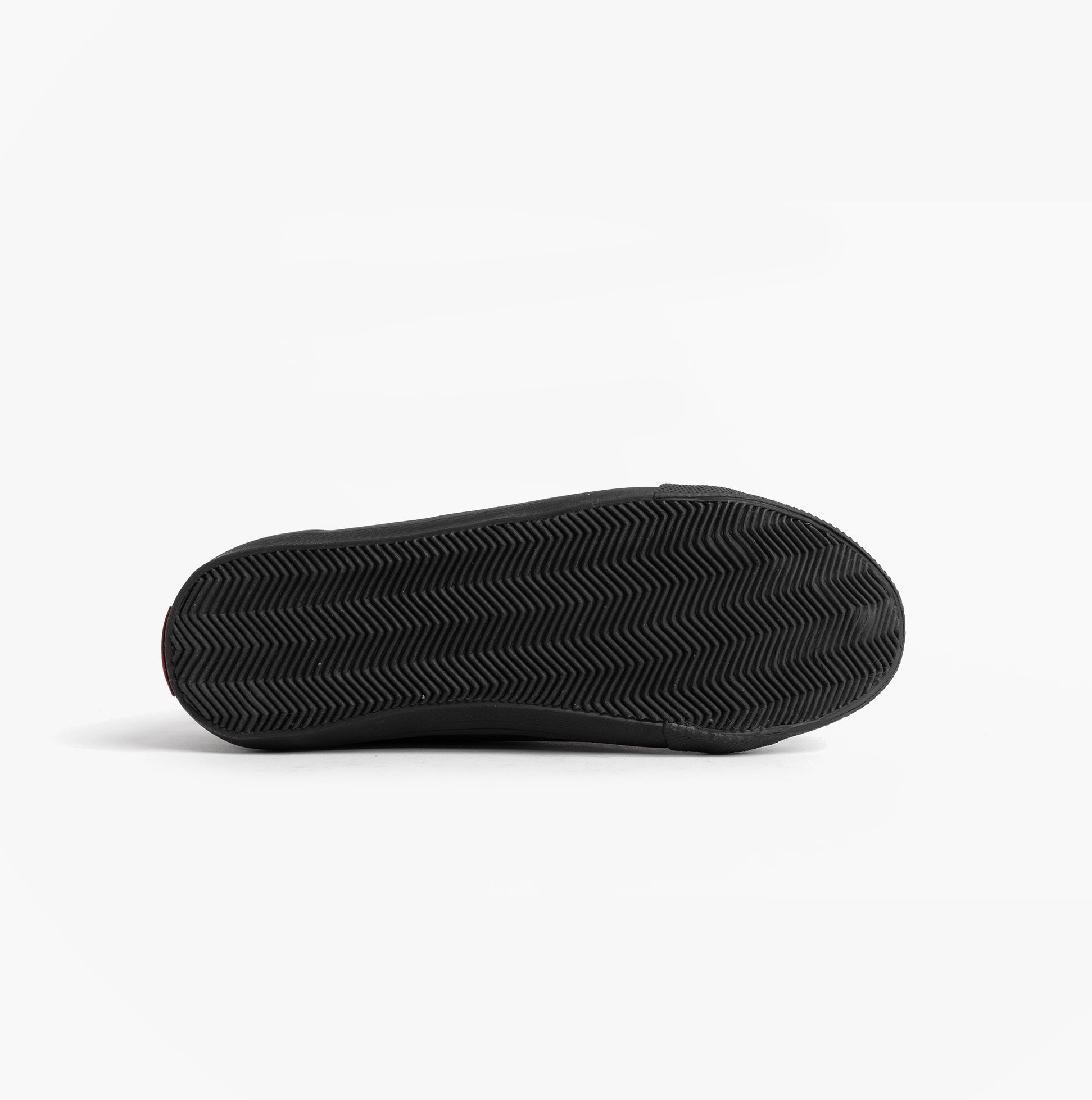 Kickers 116408 KODY LO Unisex School Shoes Black bottom view showcasing grip soles and flat heel design.