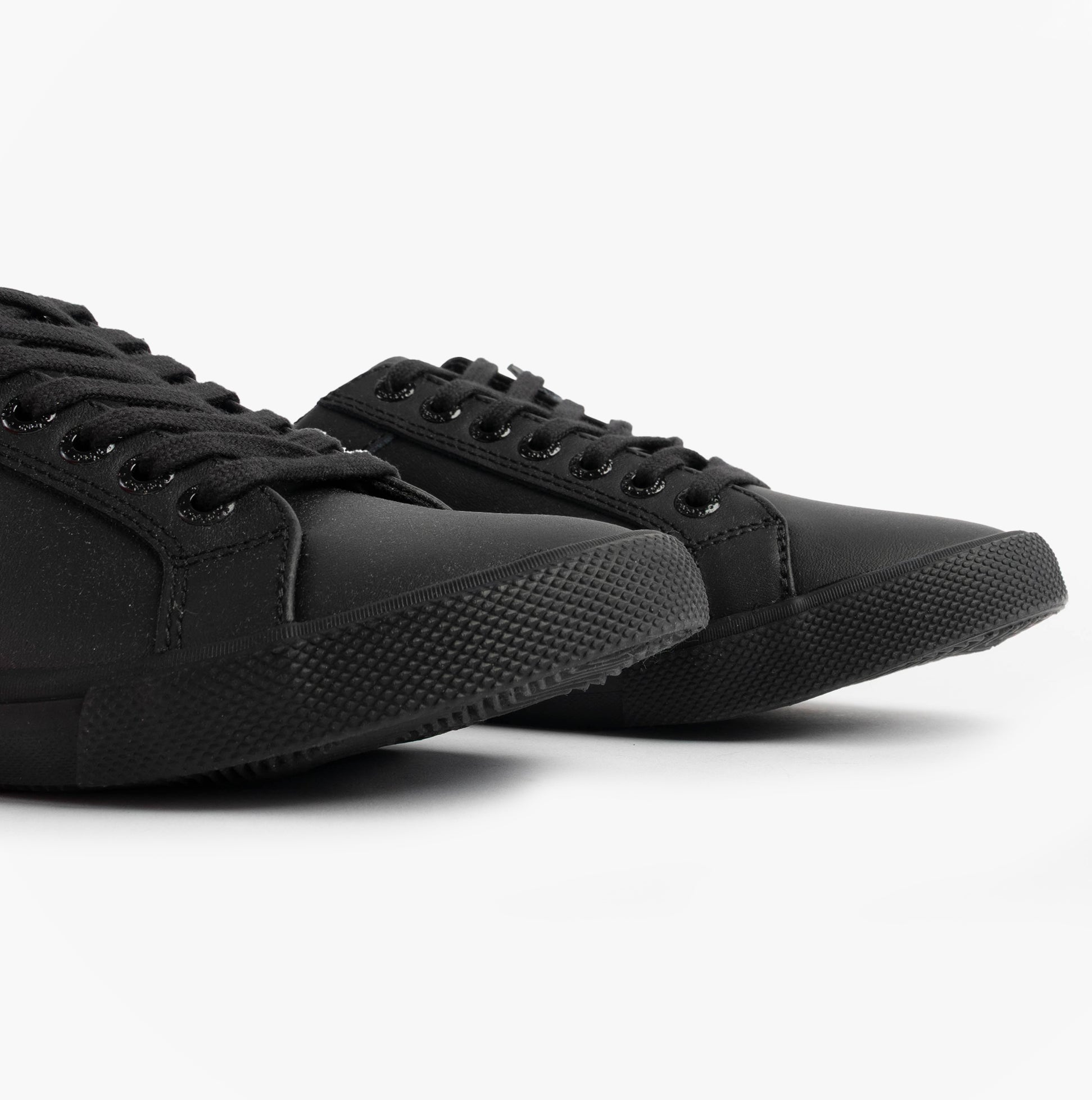 Kickers 116408 KODY LO Unisex School Shoes Black side view showcasing the flat sole and lace-up design.