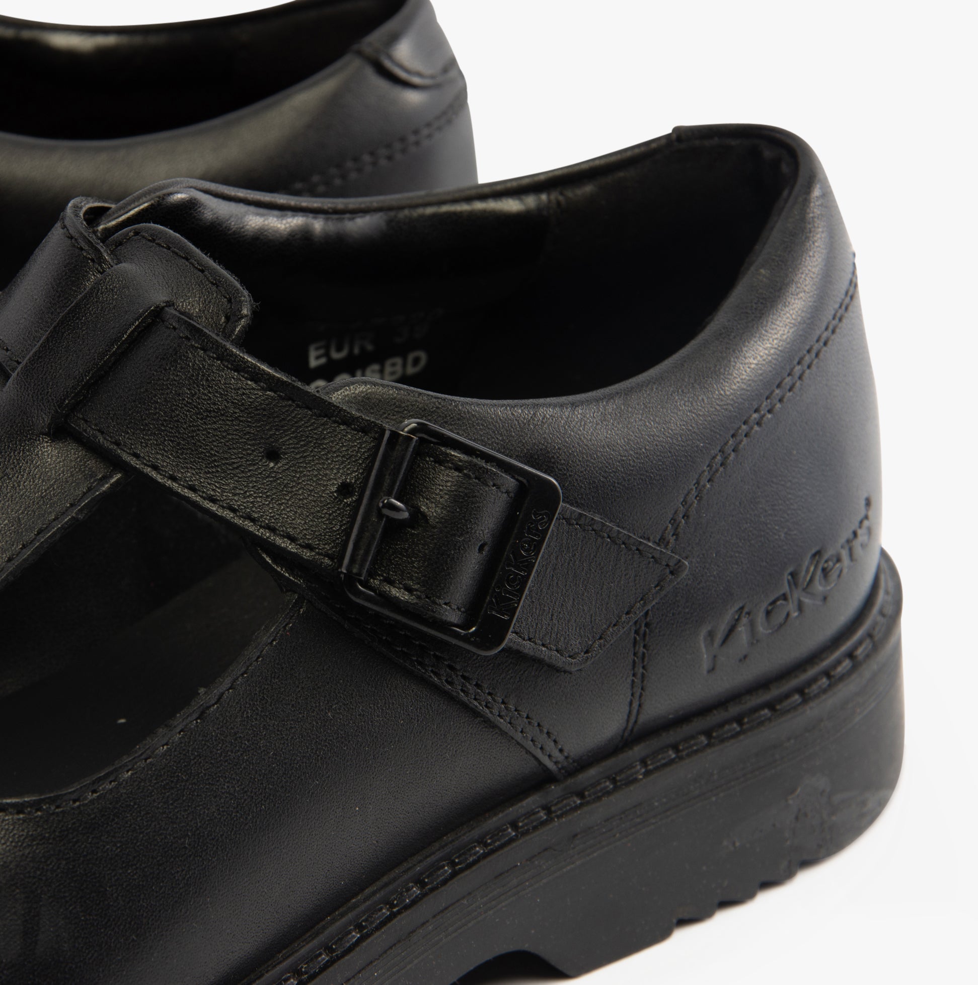 Kickers 117220 FINLEY T BAR Girls School Shoes Black detail view showcasing buckle and leather upper.