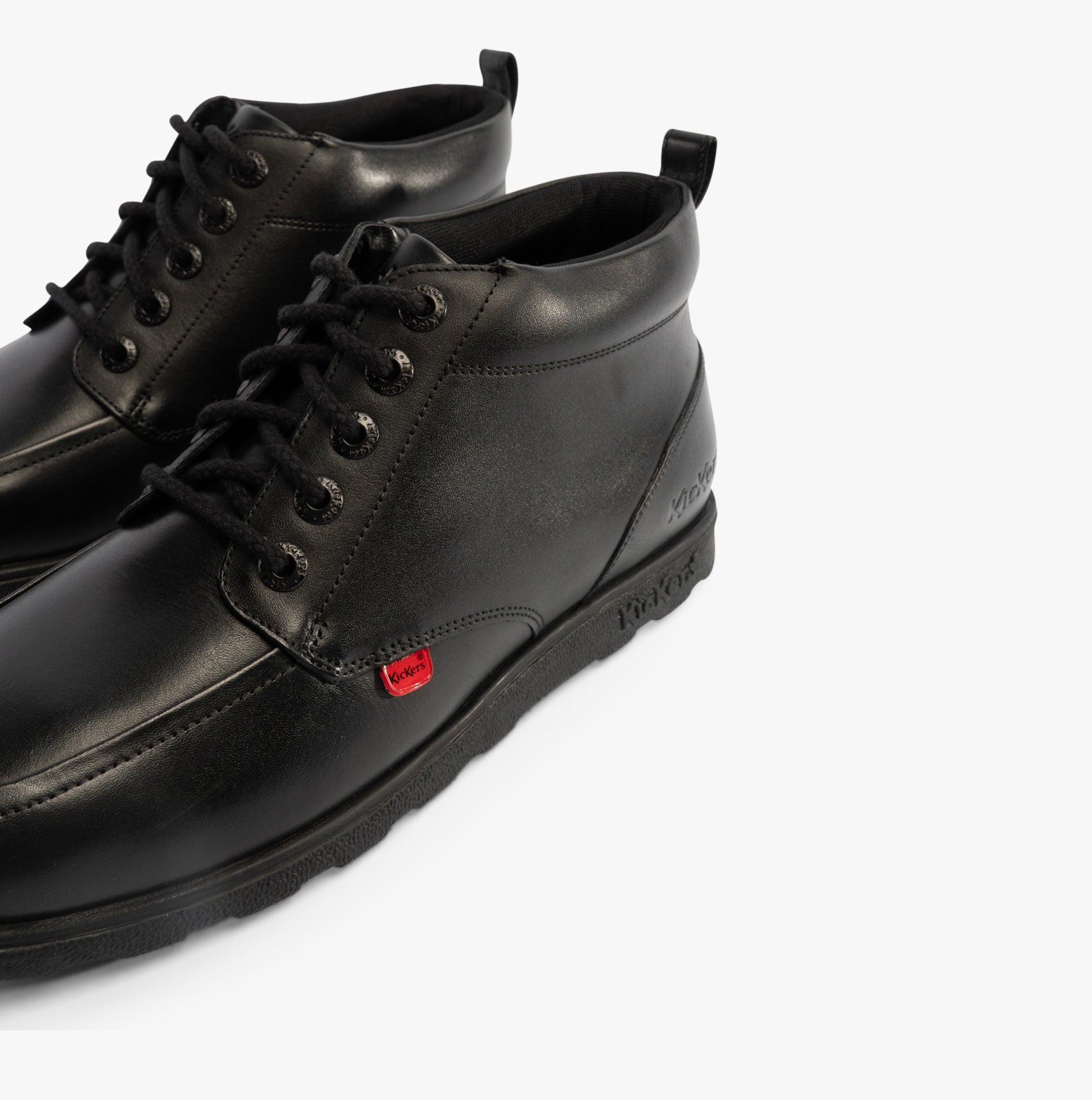 Kickers 117606 FRAGMA CHUK Boys School Boots Black side view showing lace-up closure and leather upper.