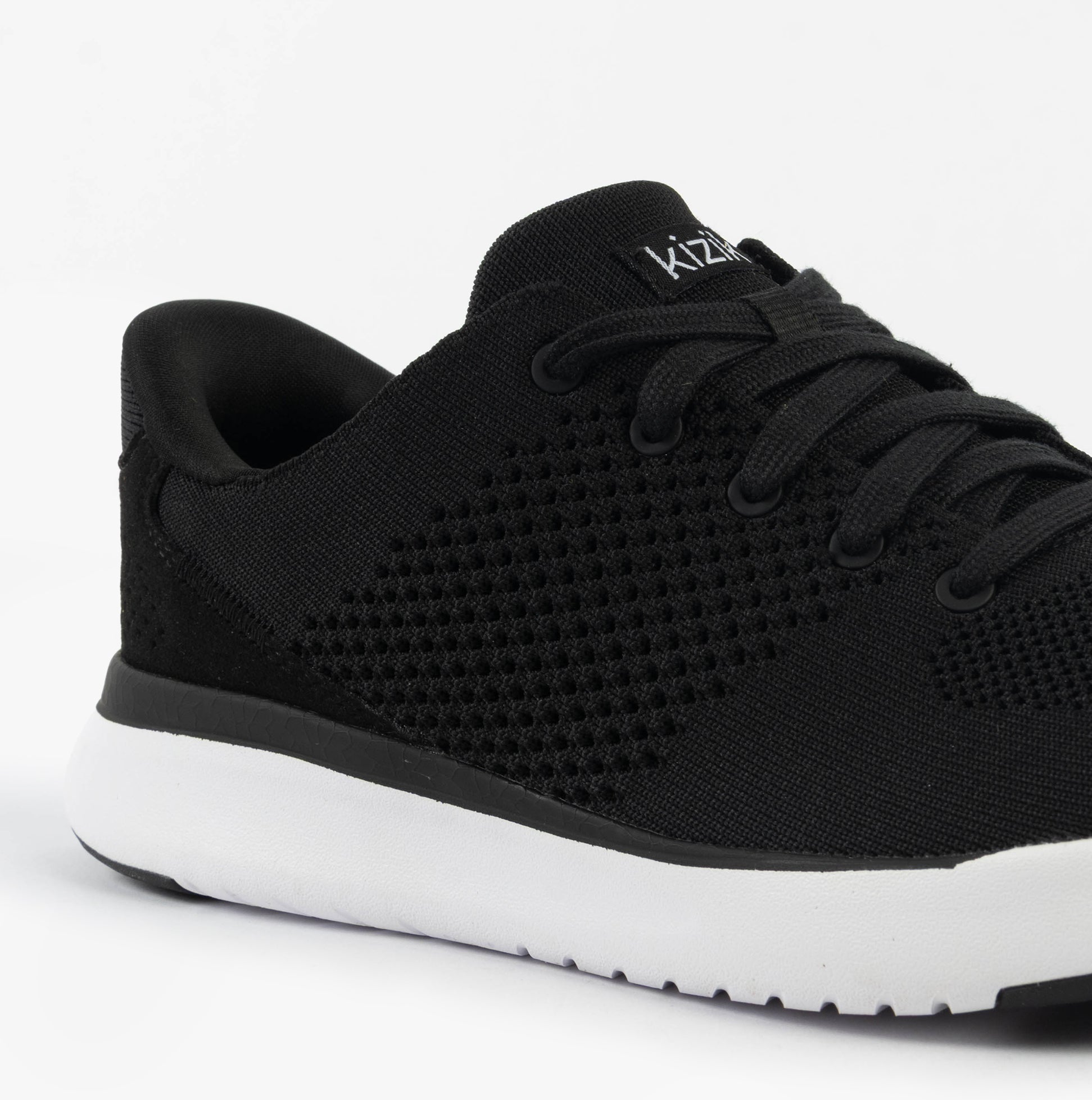 Kizik LIMA Unisex Adults Trainers Black side view showing knit upper and lace-up closure for casual comfort.