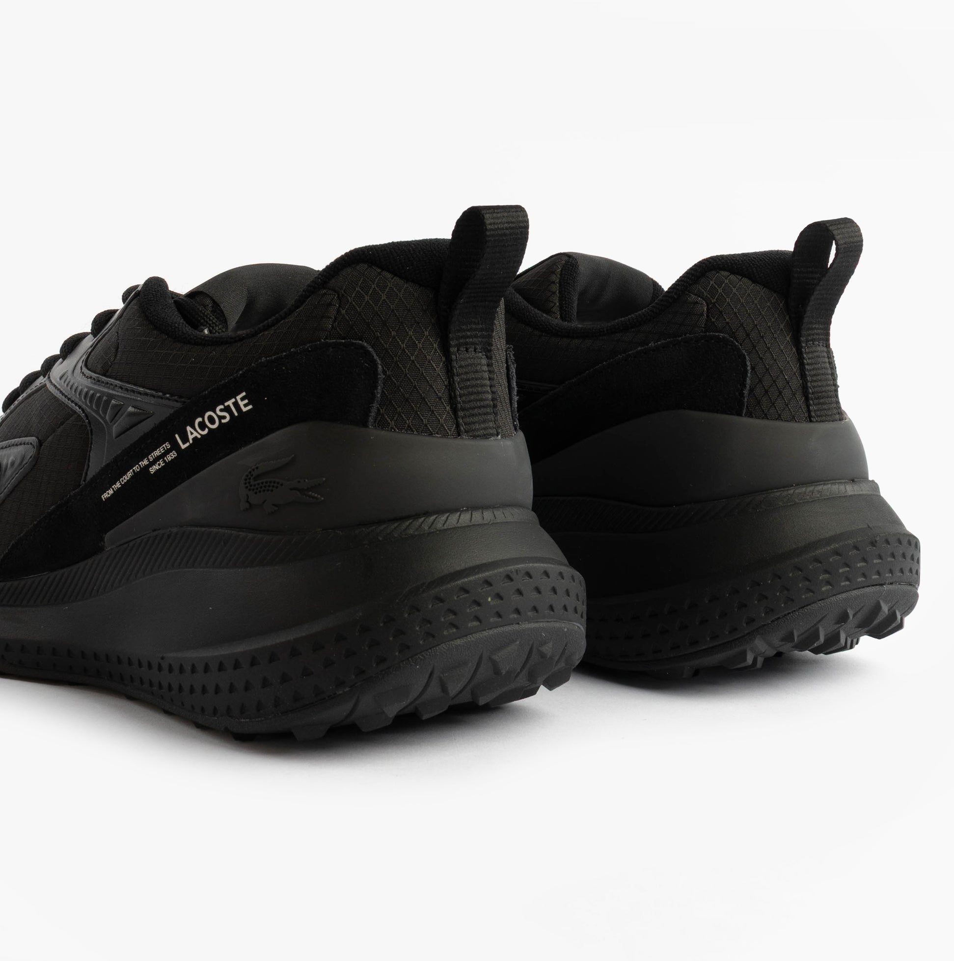 Lacoste L003 EVO Mens Performance Trainers Trainers Black rear view with rubber sole and mesh upper.