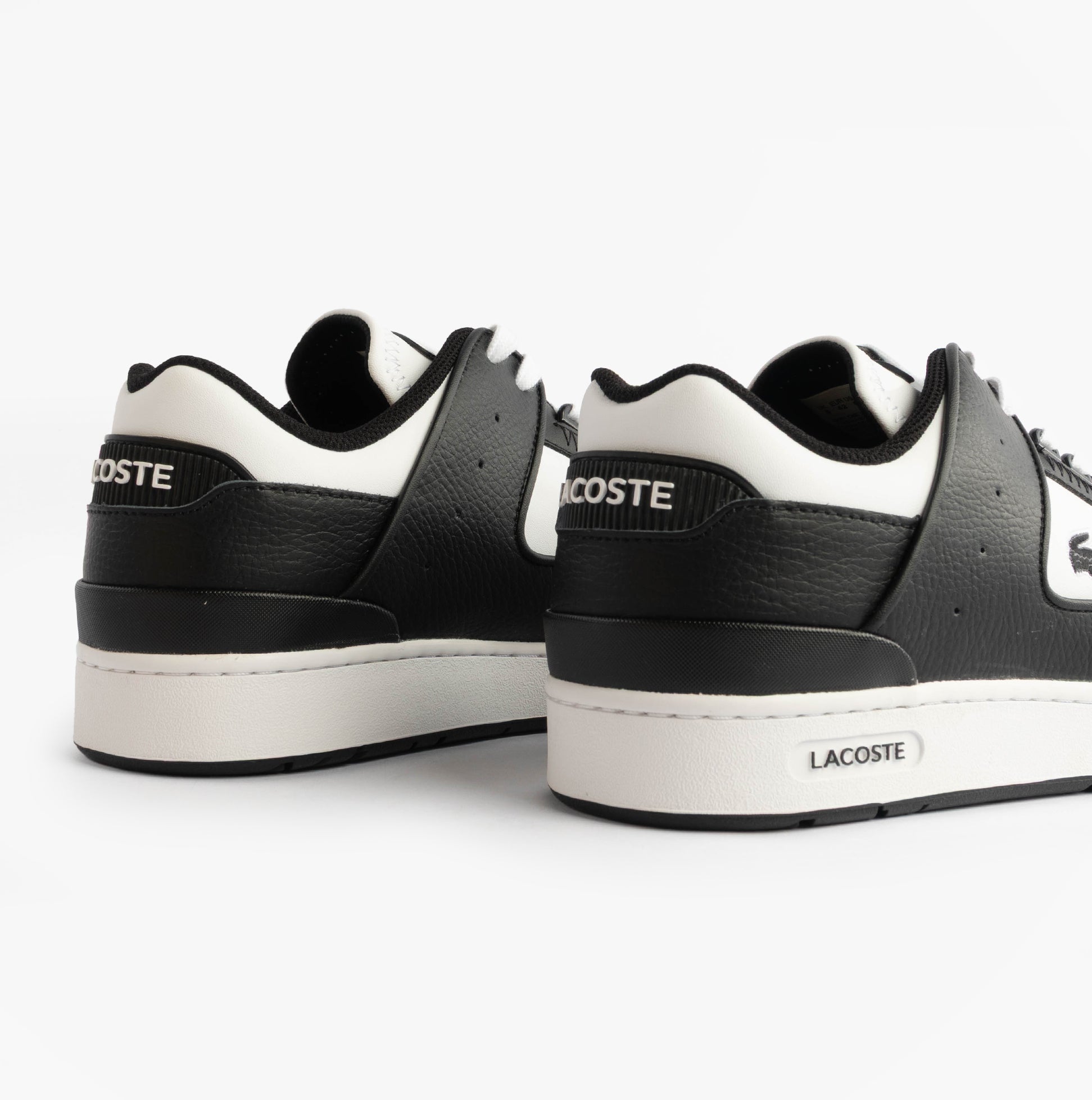 Lacoste COURT CAGE Mens Court Trainers Trainers Black/White back view showcasing low-top design and leather material.
