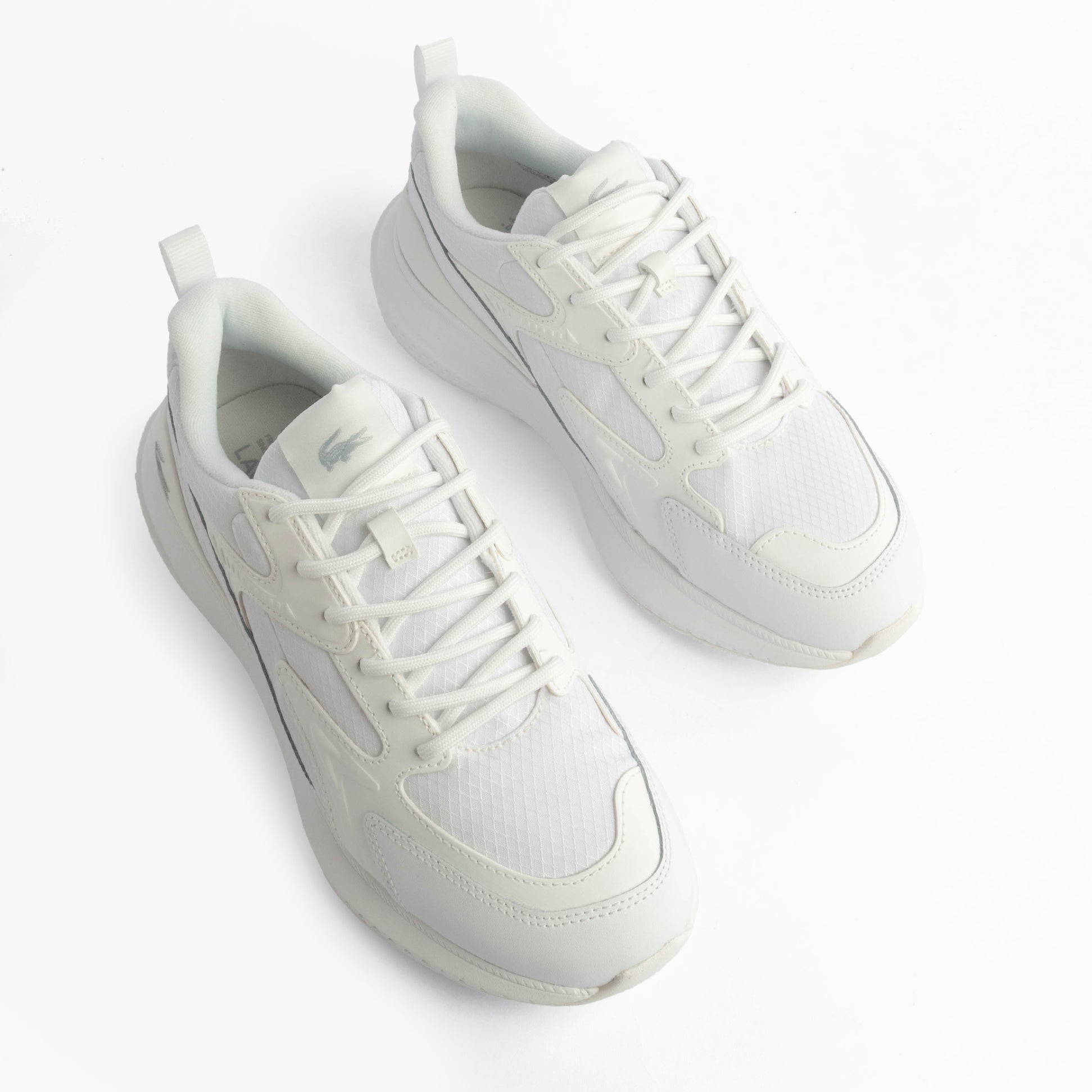 Lacoste L003 EVO Mens Performance Trainers Trainers White top view showing lace-up design and breathable material.