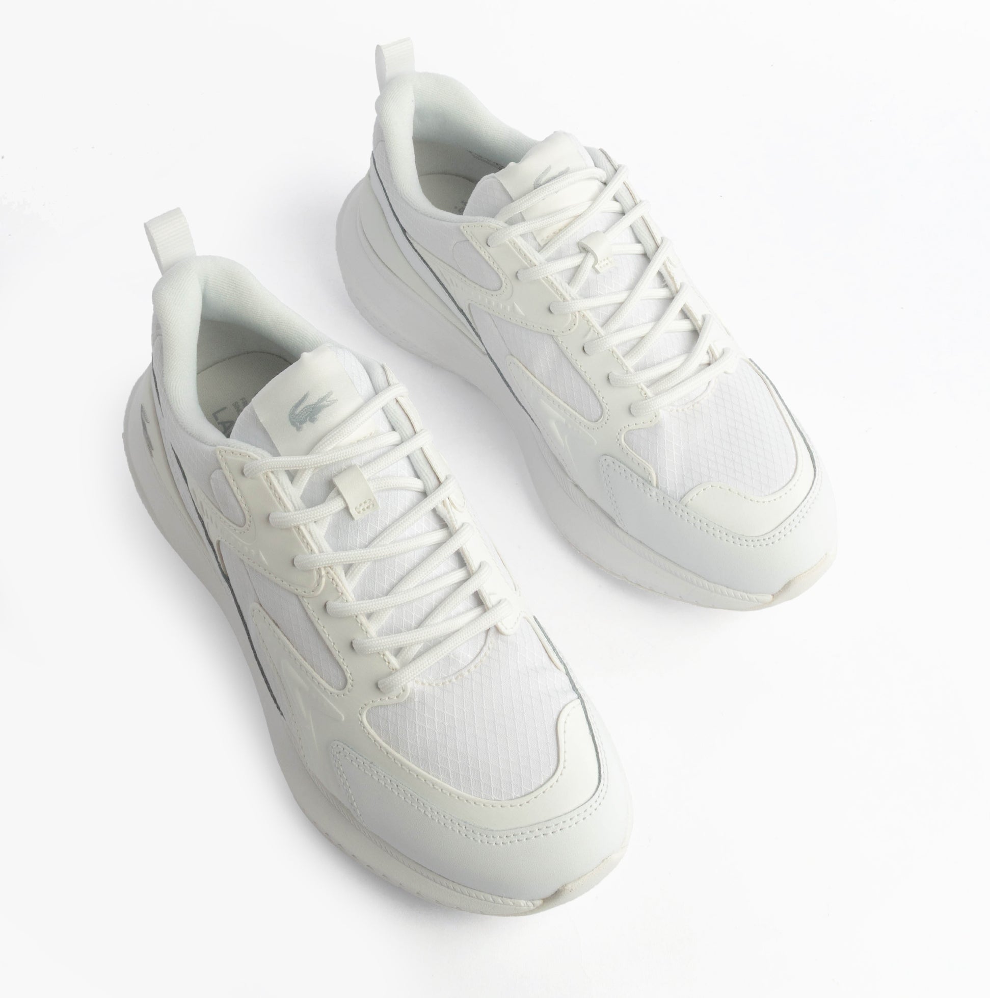 Lacoste L003 EVO Mens Performance Trainers Trainers White top view showing lace-up design and breathable material.