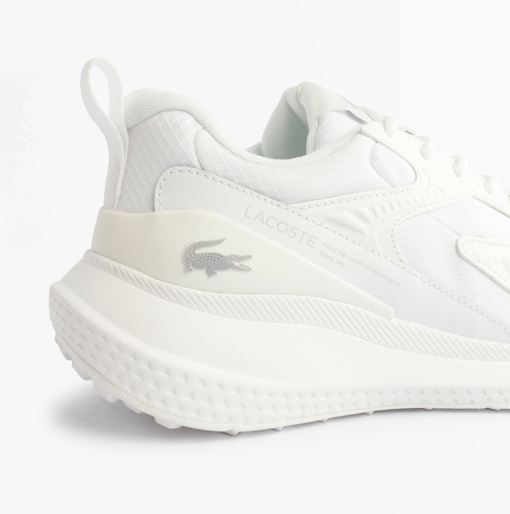 Lacoste L003 EVO Mens Performance Trainers Trainers White side view, featuring leather and mesh upper and rubber sole.