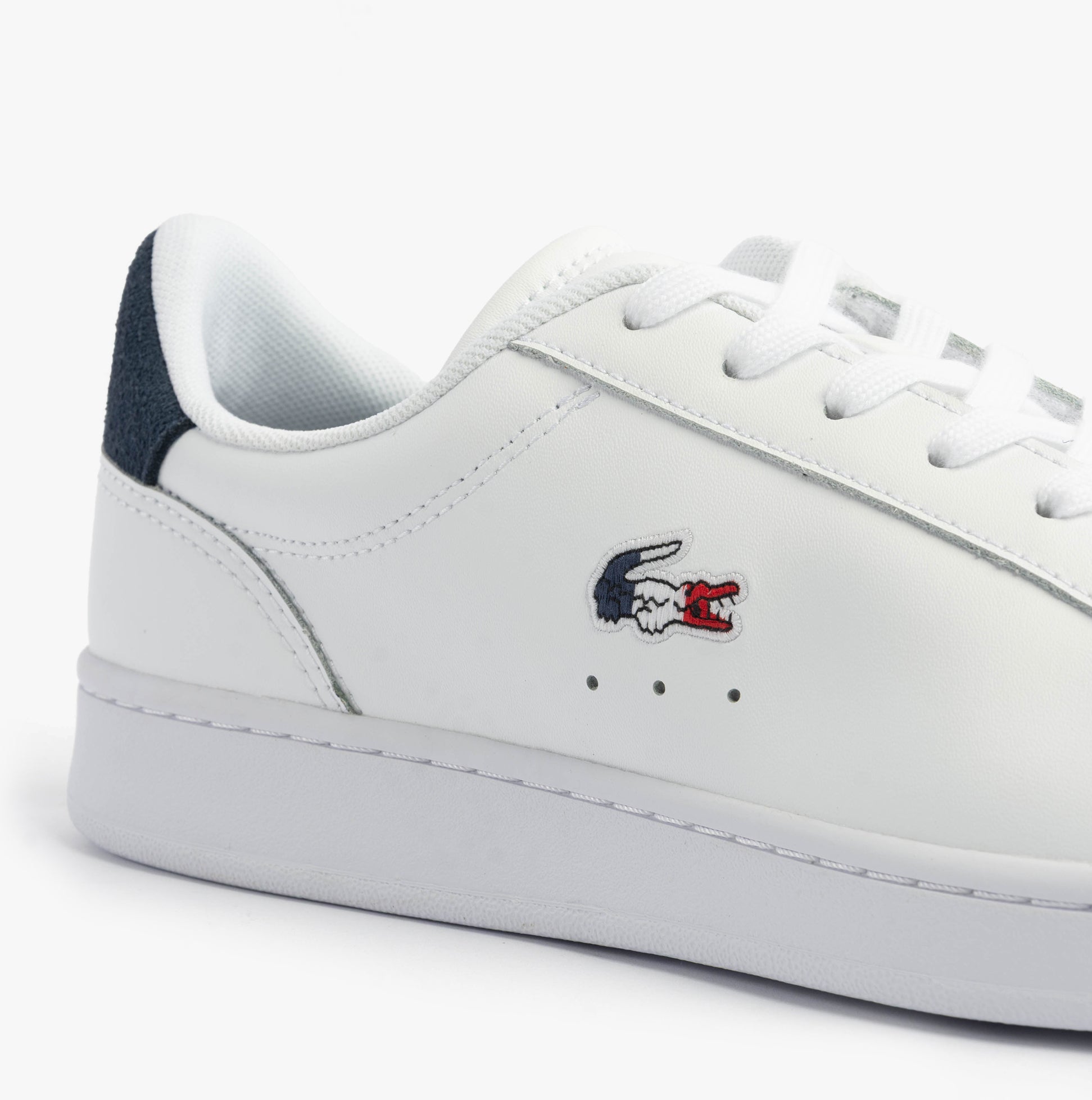 Lacoste CARNABY SET Mens Trainers White/Navy/Red side view showcasing leather upper and logo detail.