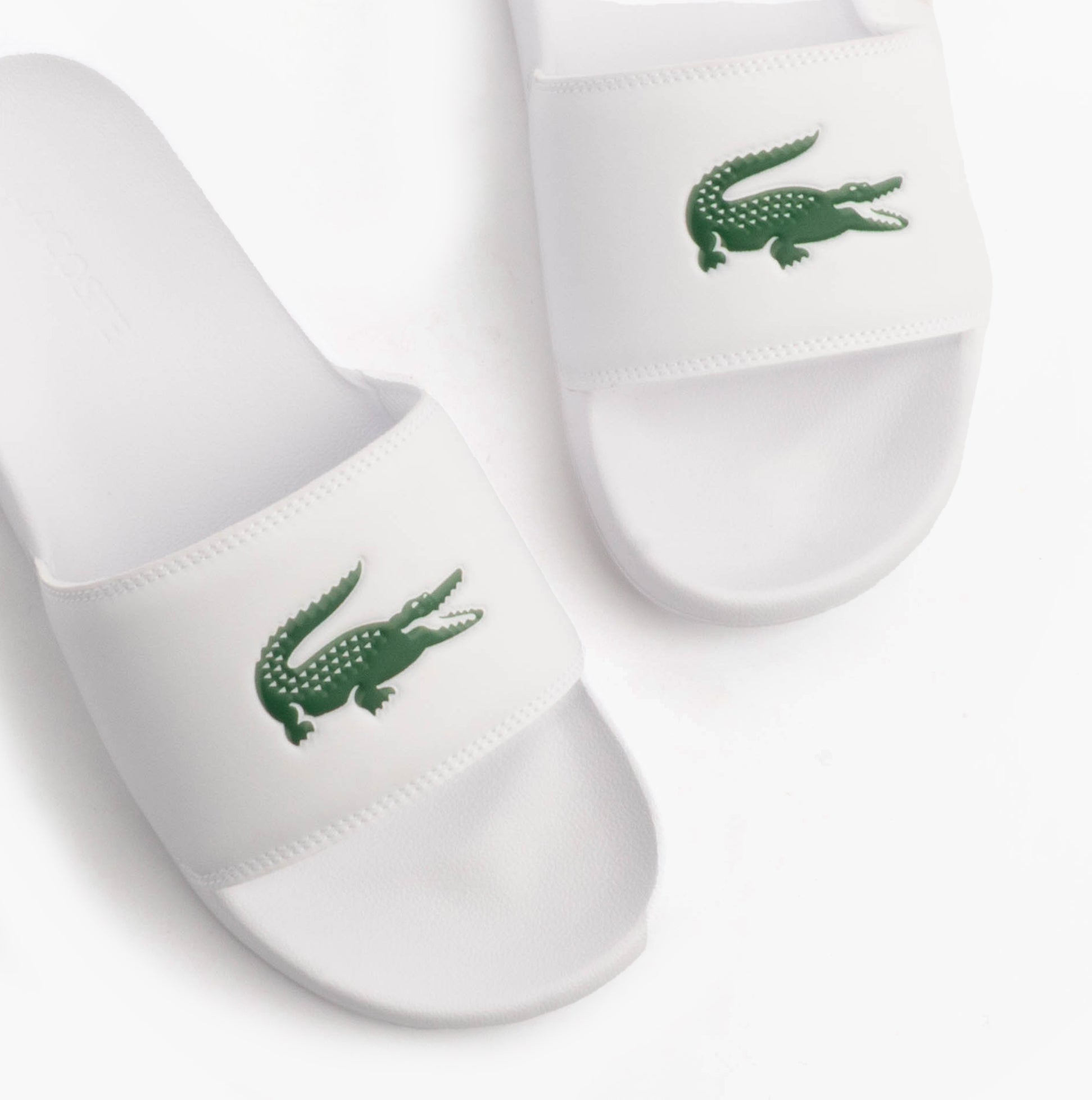 Lacoste SERVE SLIDE 0.0 Mens Slides White/Green top view showing logo and detail of slide design.