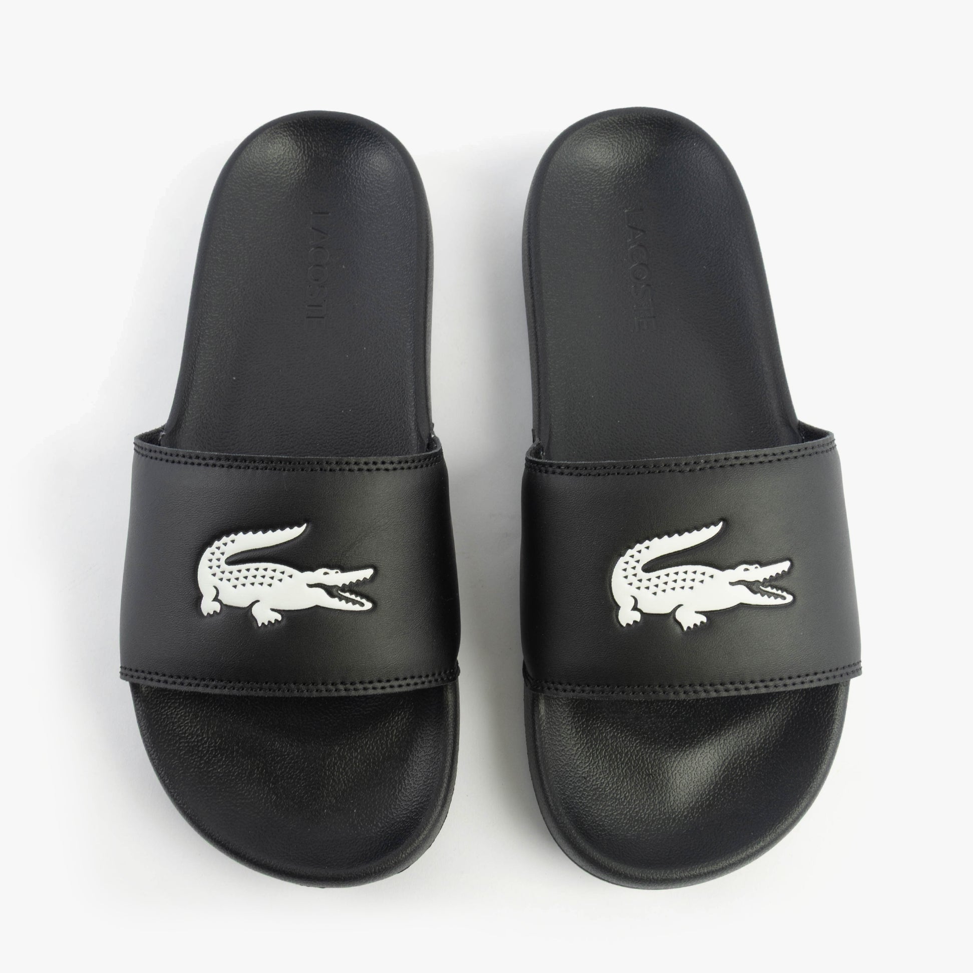 Lacoste SERVE SLIDE 0.0 Mens Slides Black/White top view showing black EVA upper and white logo.