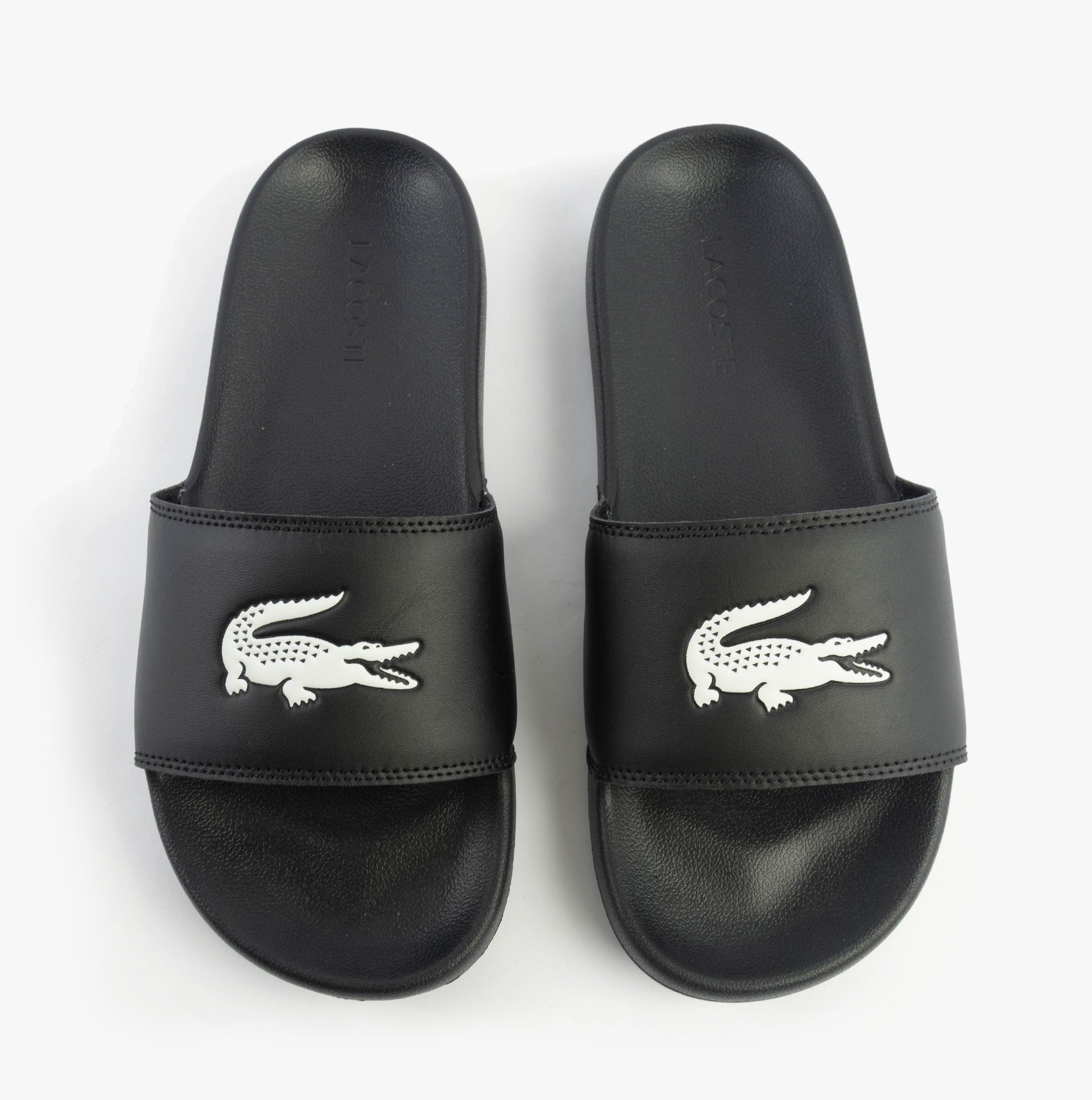 Lacoste SERVE SLIDE 0.0 Mens Slides Black/White top view showing black EVA upper and white logo.