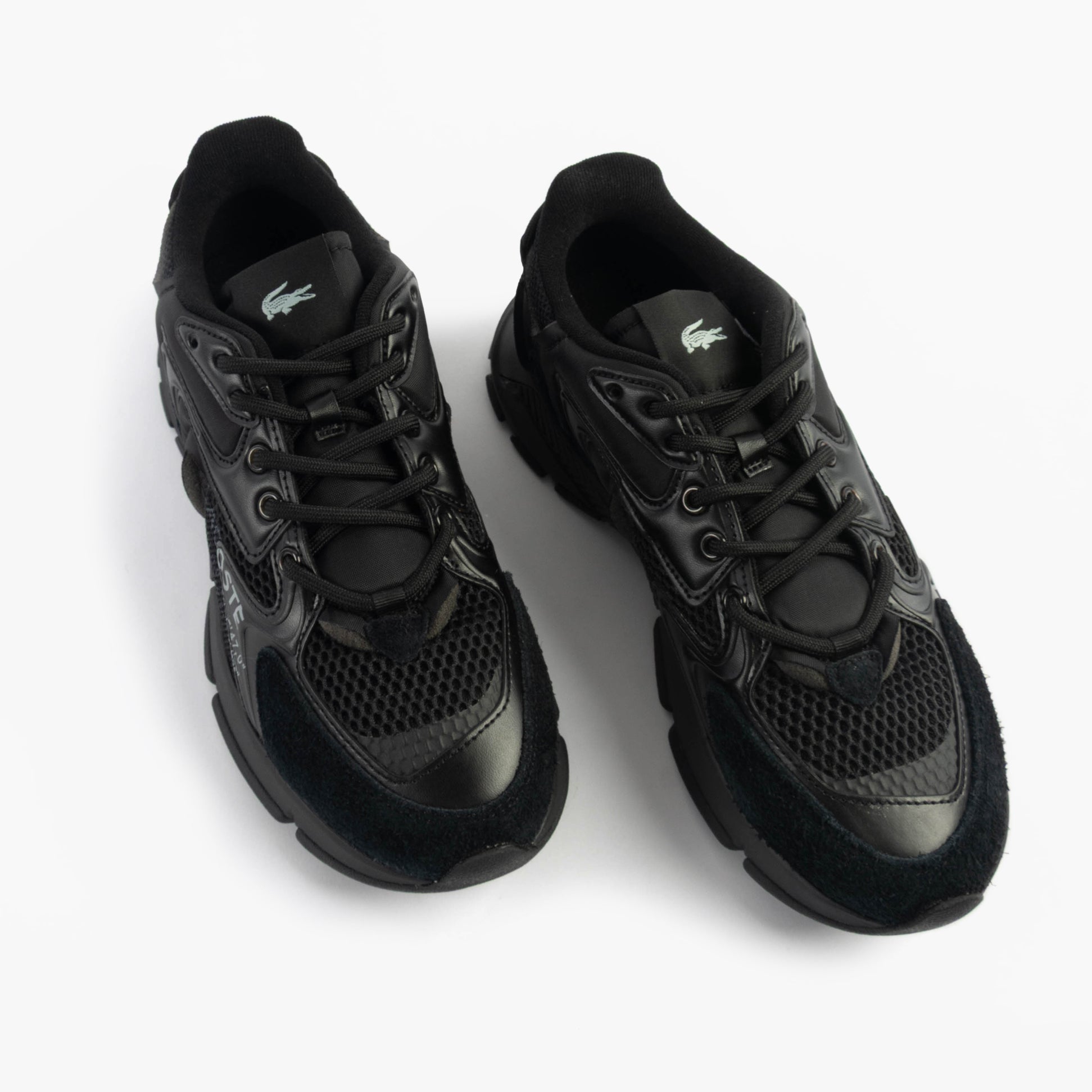 Lacoste L003 NEO Mens Trainers Black top view showcasing lace-up design and leather material.