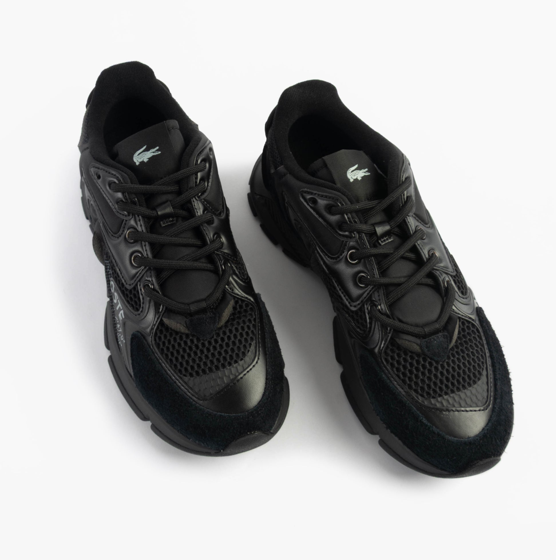 Lacoste L003 NEO Mens Trainers Black top view showcasing lace-up design and leather material.