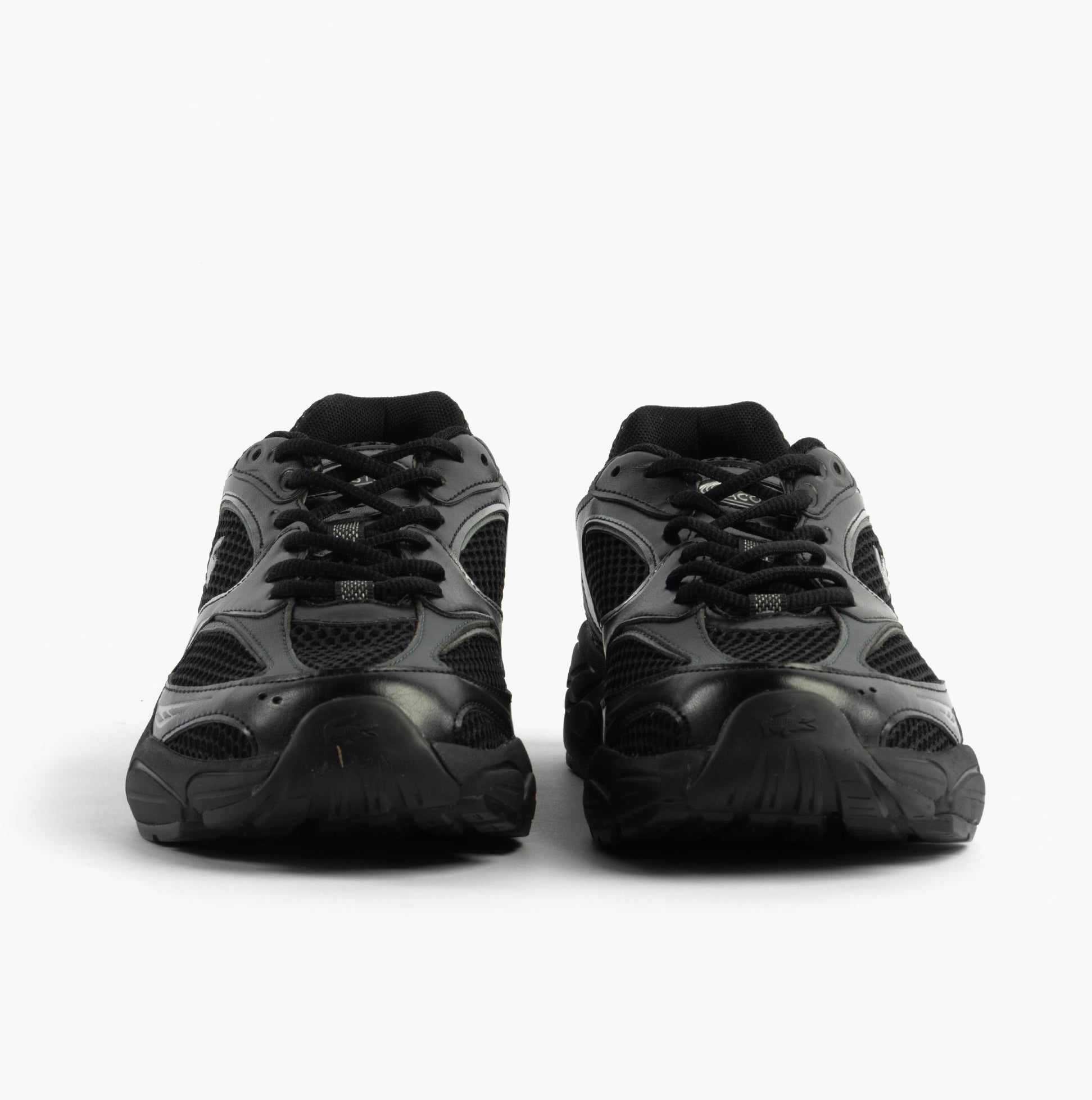 Lacoste STORM 96 2K Mens Trainers Black front view showing lace-up closure and low top design.