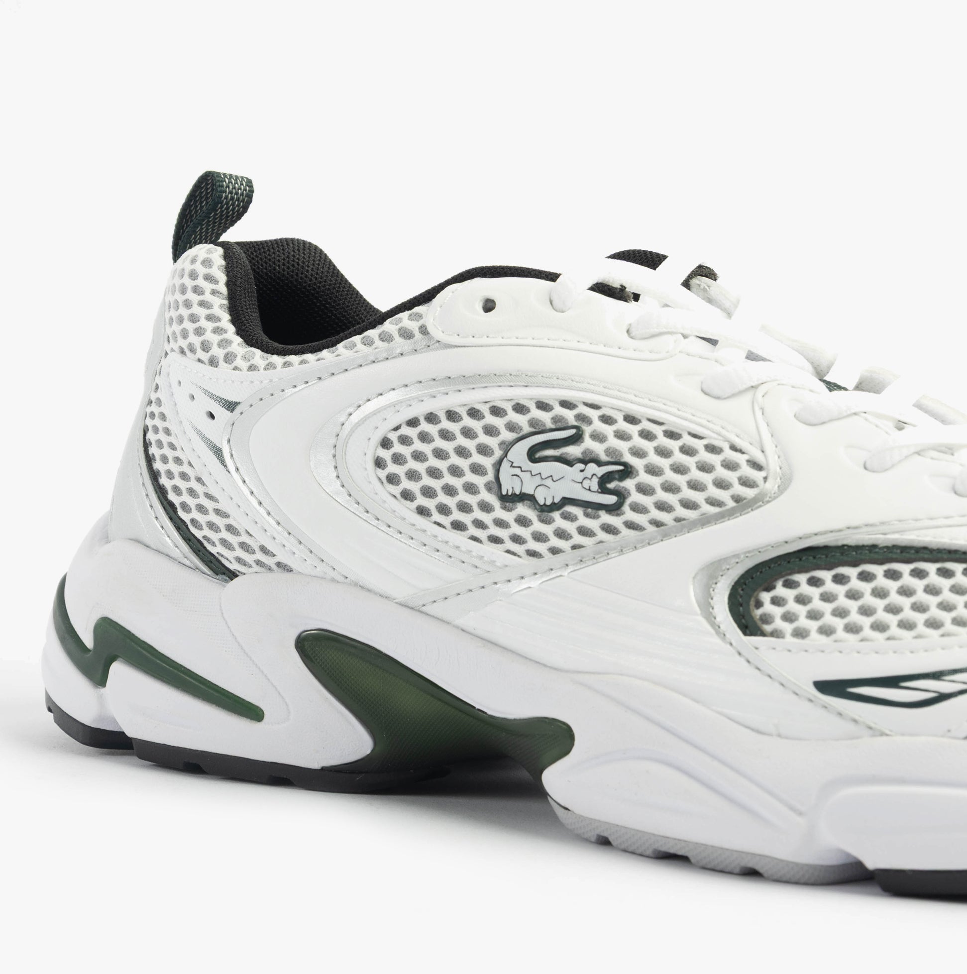 Lacoste STORM 96 2K Mens Trainers White/Dark Green side view showcasing mesh and leather details.
