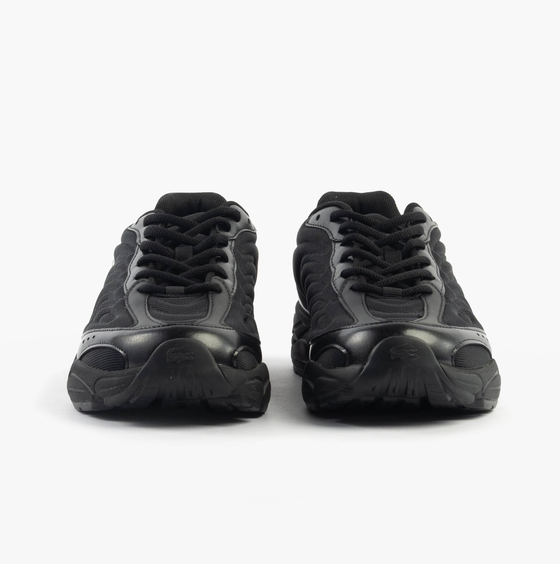 Lacoste STORM 96 2K LITE Mens Trainers Black front view showcasing sleek design and lace-up closure.