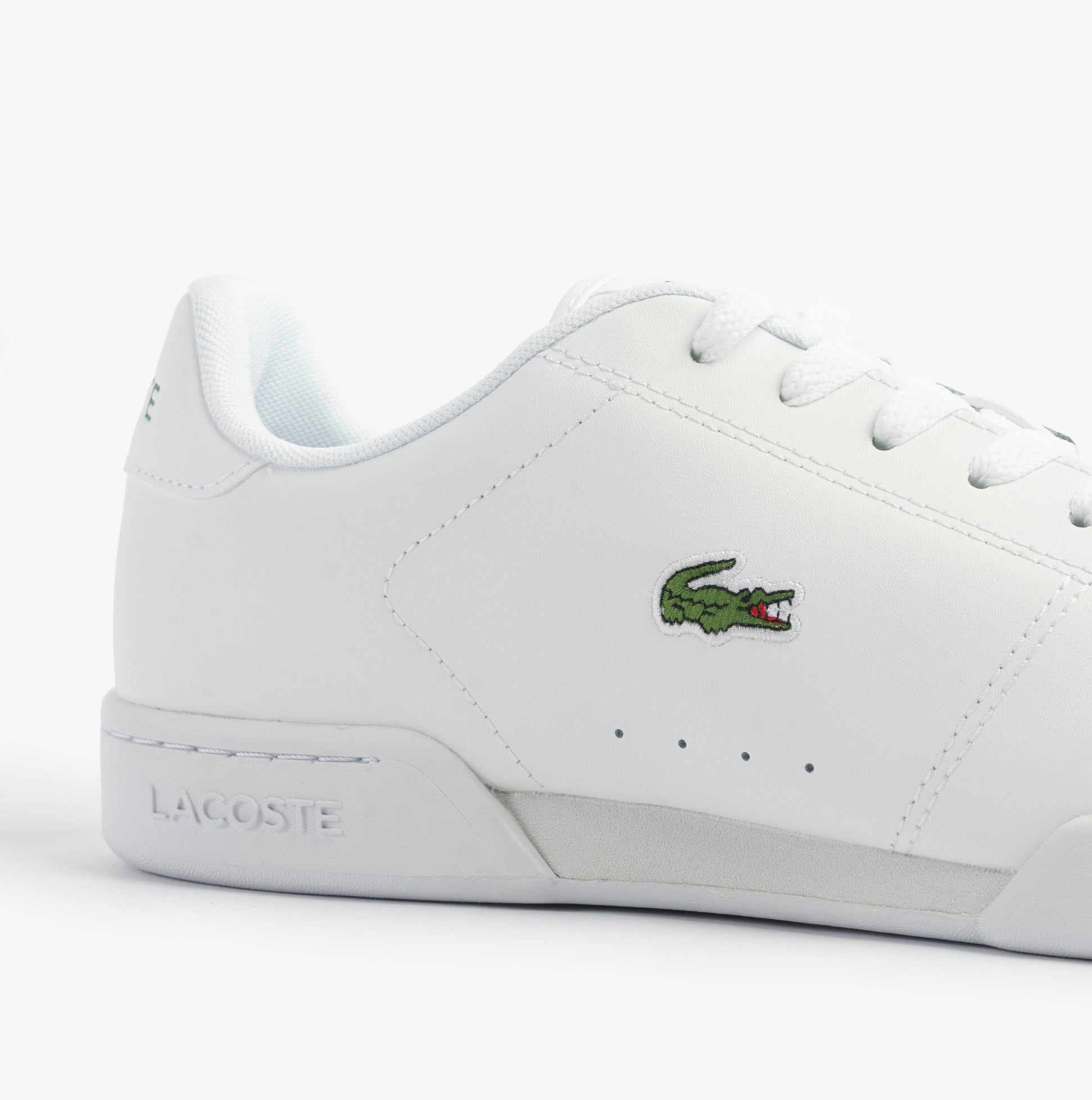 Lacoste CARNABY CUP Mens Trainers White side view showcasing leather upper and iconic logo detail.