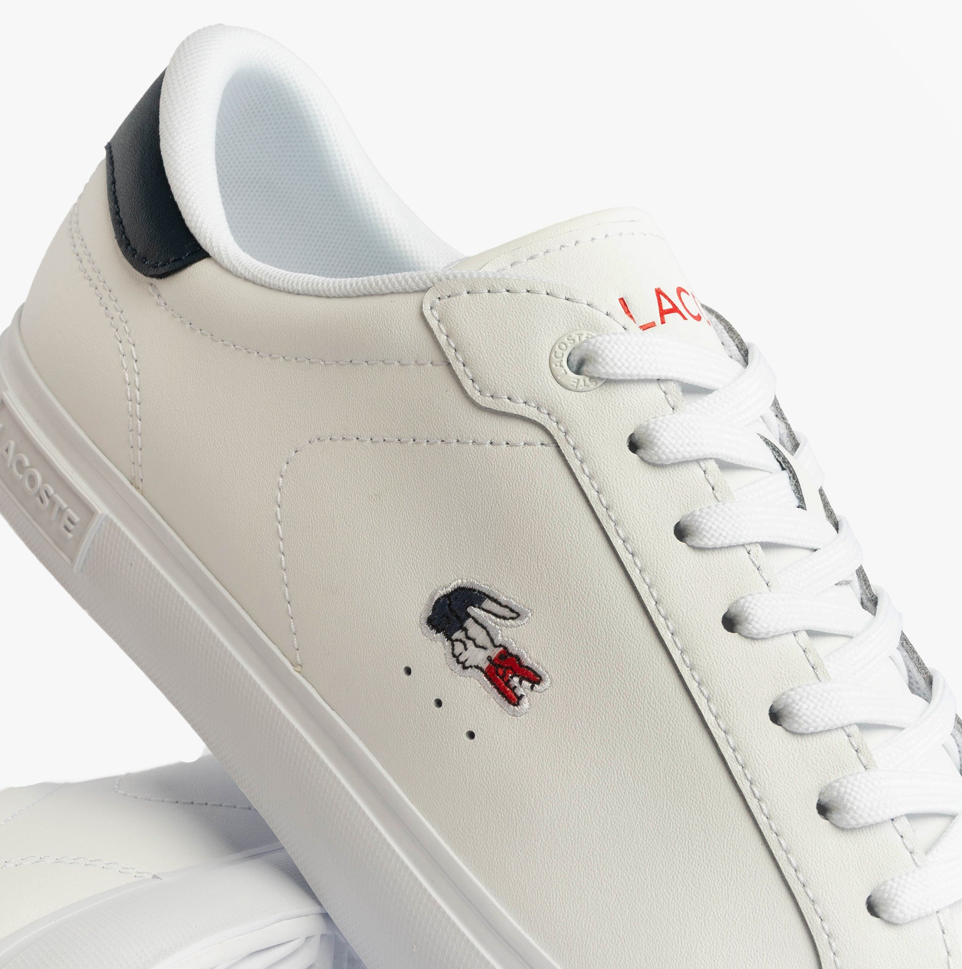 Lacoste POWERCOURT Mens Court Trainers Trainers White/Navy/Red side view displaying leather upper and embroidered logo.
