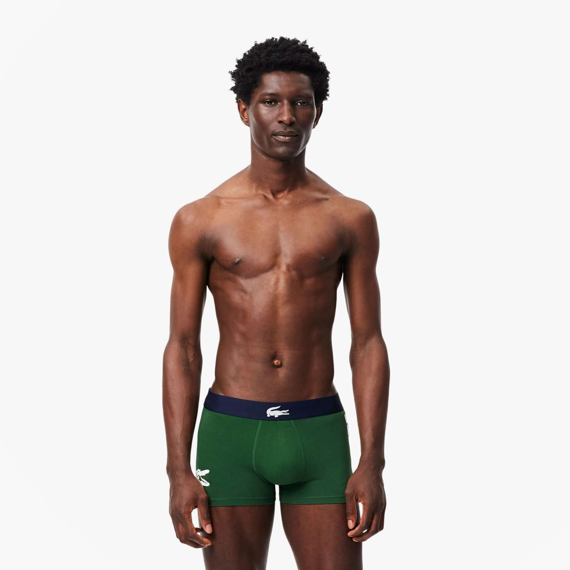 Lacoste 3 Pack Trunks Mens Trunks Thyme/Navy Blue/White front view model wearing green trunks.
