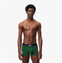 Lacoste 3 Pack Trunks Mens Trunks Thyme/Navy Blue/White front view model wearing green trunks.