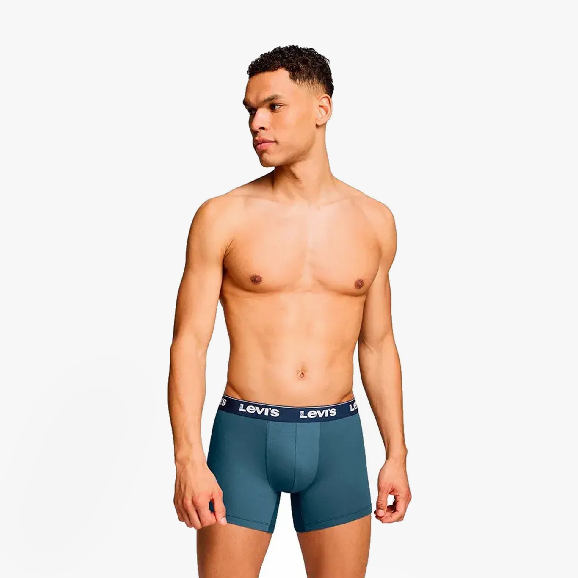 Levi's REPEAT LOGO Mens 3 Pack Trunks Navy Combo side view on male model wearing trunks with elastic waistband.