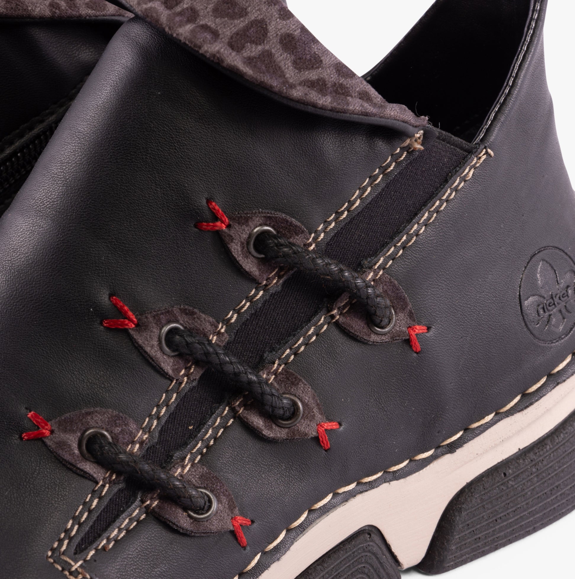 Rieker 45983-00 Womens Boots Black detail view showing laces and synthetic leather upper.
