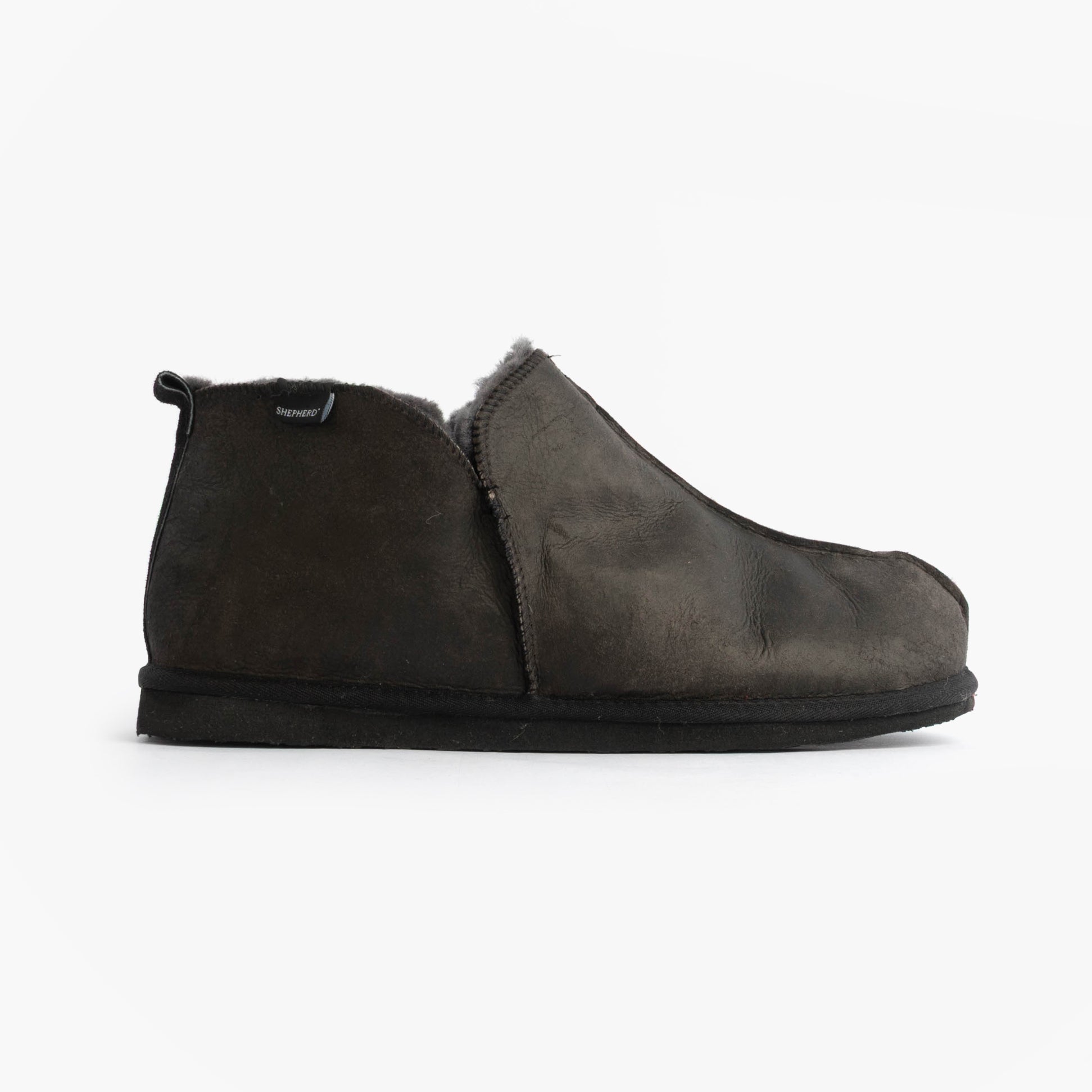 Shepherd ANTON Mens Slippers Matt Black side view showing leather/suede upper and flat rubber sole.
