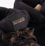 Detail view of Skechers 144194/BLK GLACIAL ULTRA-TREND UP Womens Boots Black featuring logo and lace detail.