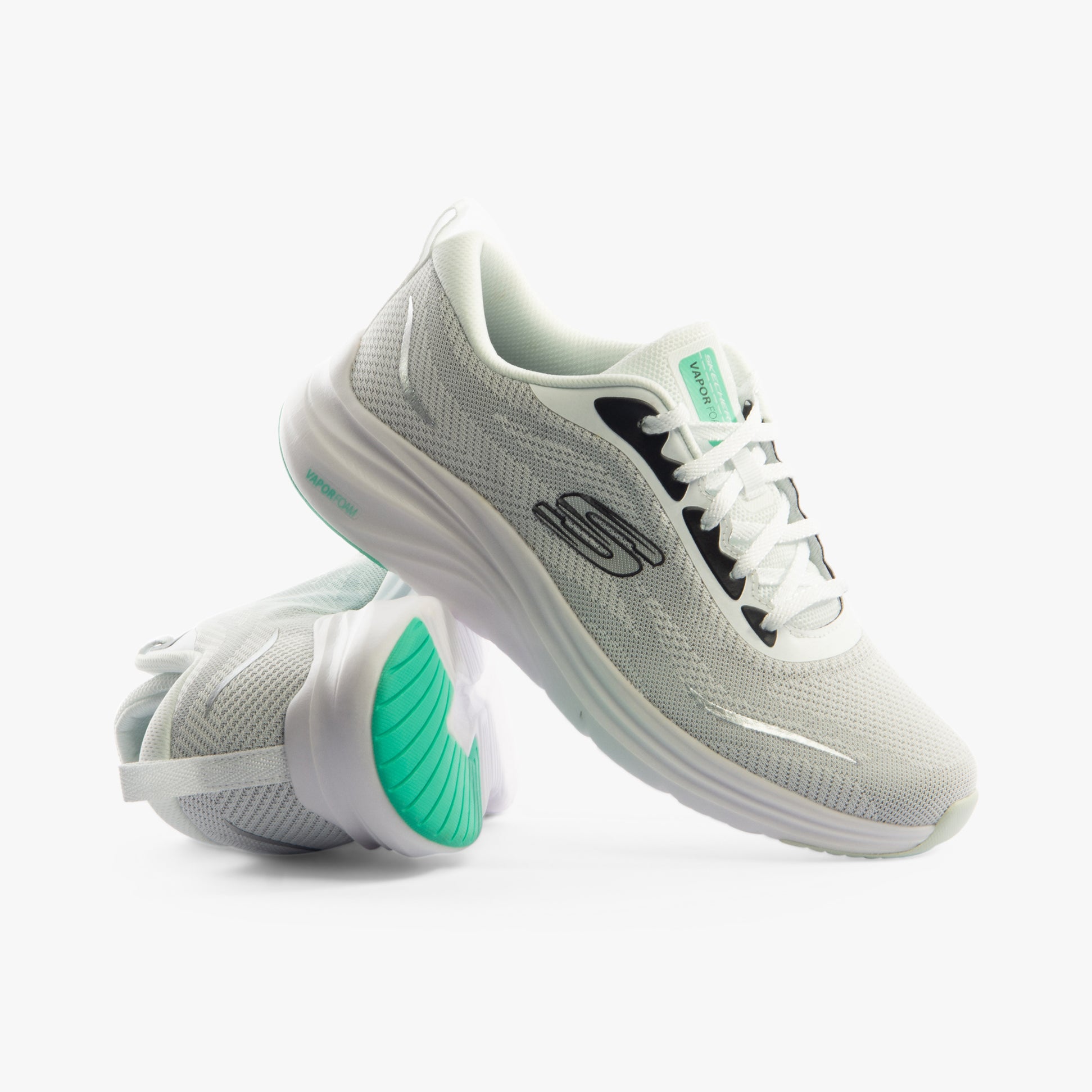 Skechers 150028/WBK VAPOR FOAM - SMOOTH RIDE Womens Trainers White/Black side view with smooth textile upper and rubber sole.