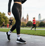 Skechers 150450/BLK ULTRA FLEX 3.0-EASY WIN Womens Trainers Black side view worn by a runner in a park.