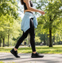 Skechers 150457/BBK ULTRA FLEX 3.0-ELEVATED MOTION Womens Trainers Black side view on a woman walking in a park.