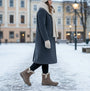Skechers 168045/DKTP EASY GOING - DREAMERS MOVE Womens Boots Dark Taupe side view worn in snowy setting.