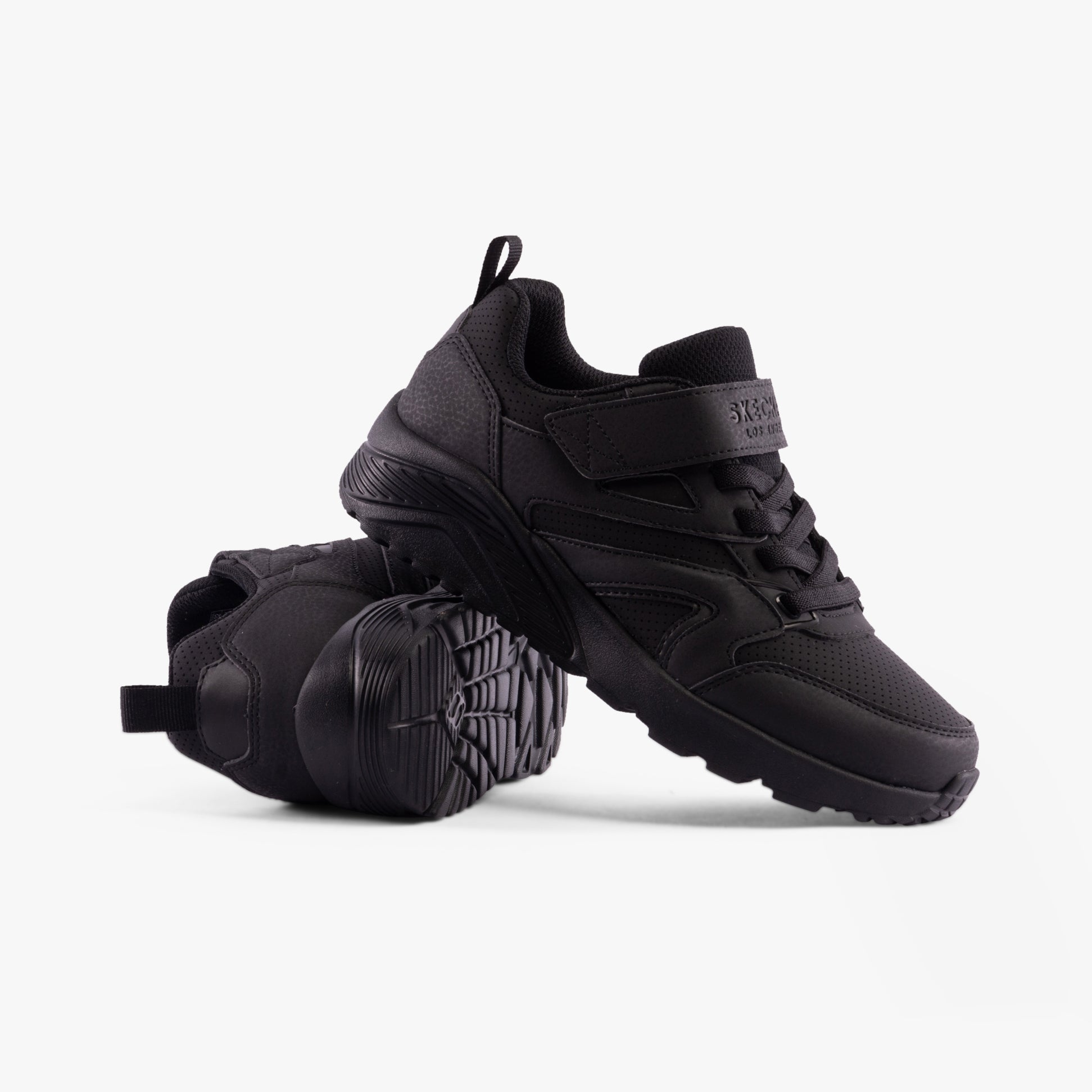 Skechers 403640L/BBK UNO LITE - ECHO SURGE Boys Trainers Black side view showing sleek design and rubber sole.