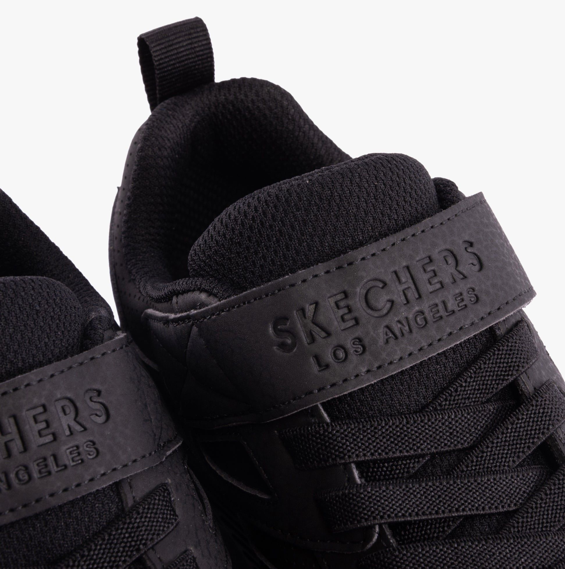 Skechers 403640L/BBK UNO LITE - ECHO SURGE Boys Trainers Black close-up view showing shoe details and branding.
