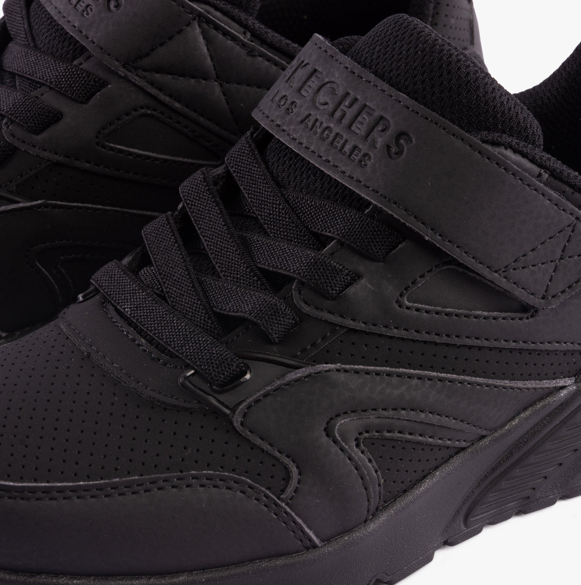 Skechers 403640L/BBK UNO LITE - ECHO SURGE Boys Trainers Black close-up view highlighting lace-up design and black synthetic upper.